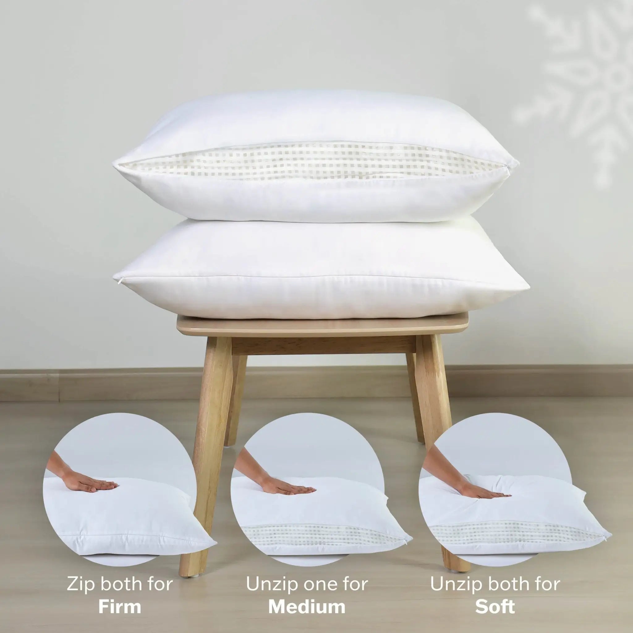 Two white pillows on a wooden stool with instructions on adjusting firmness.
