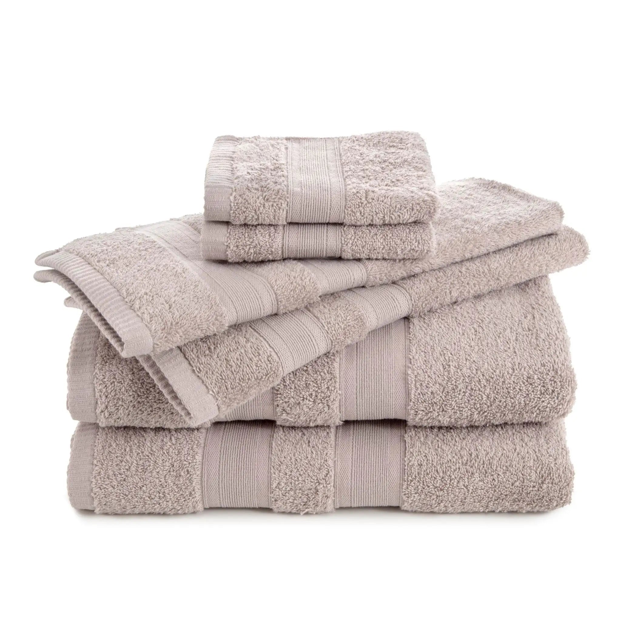 Stack of sand color towel set on a white background