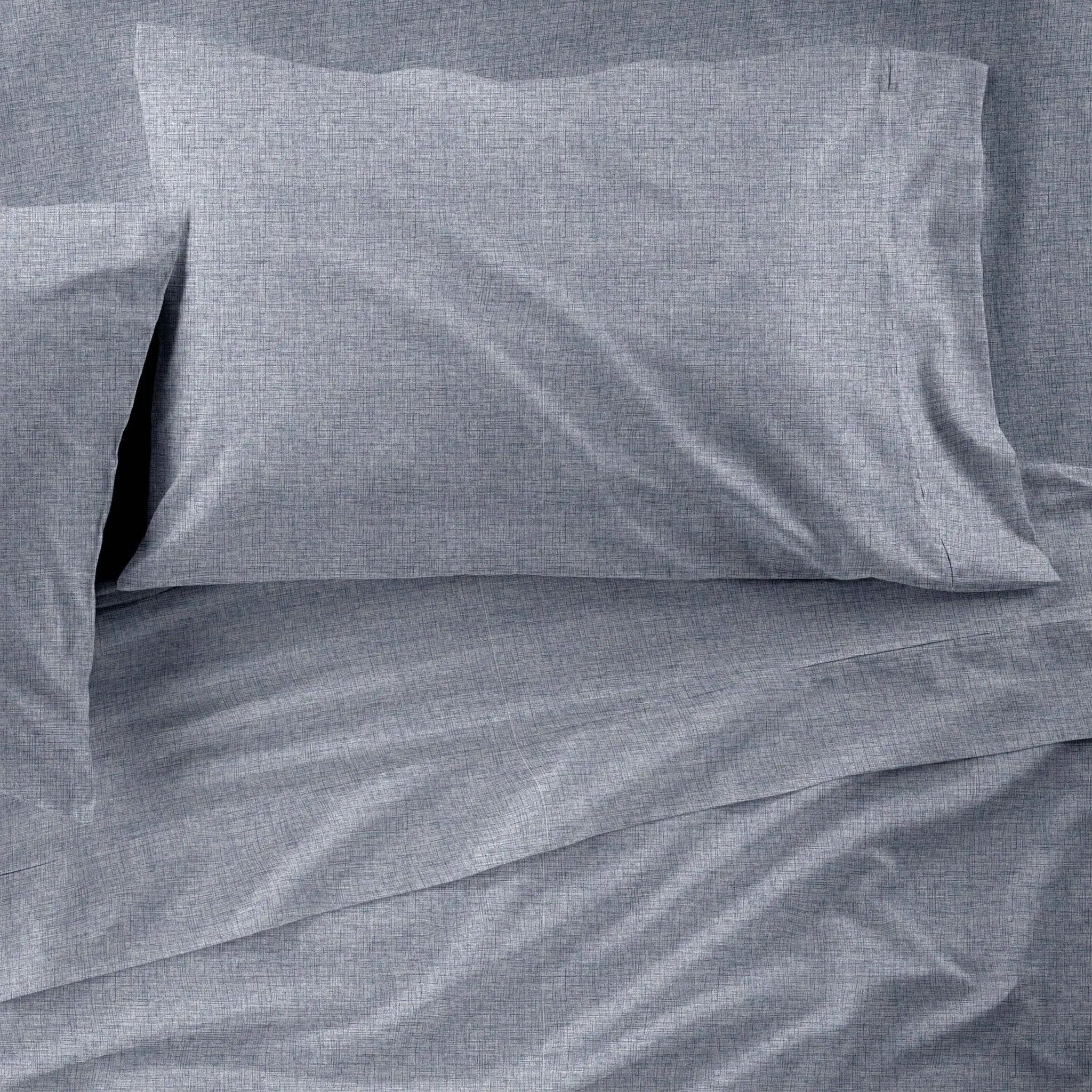 Gray checkered pillowcases on a matching fabric background