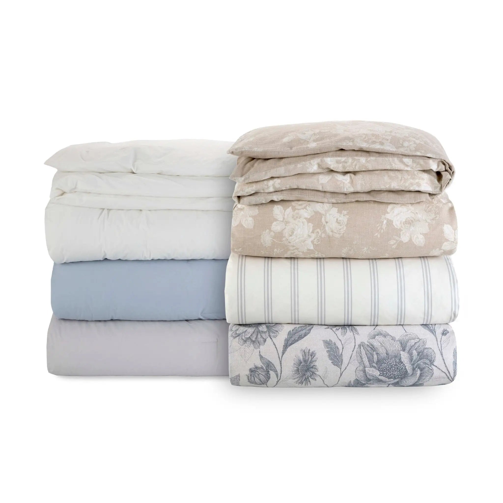 Stack of folded bed sheets with solid, floral and striped patterns on a white background