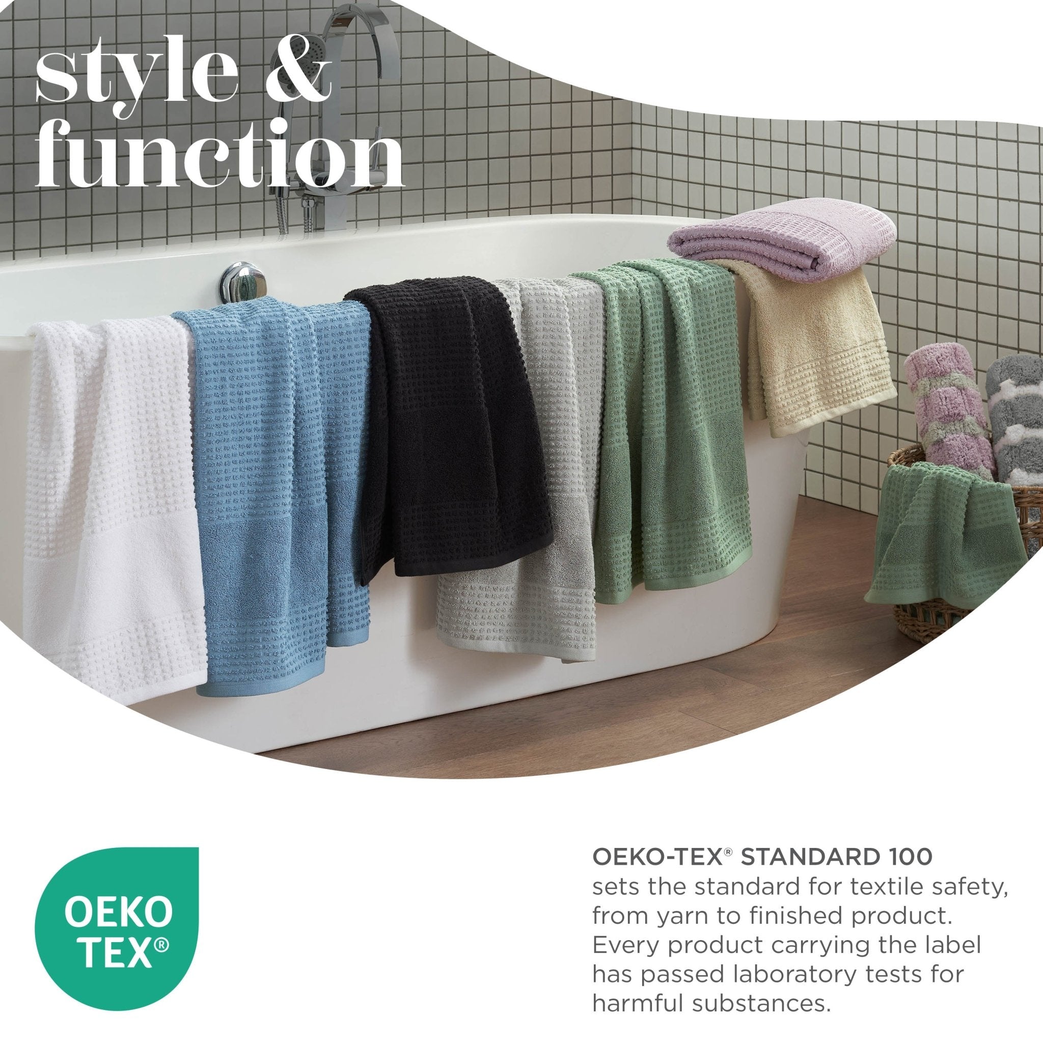 Colorful towels hanging over a bathtub with Oeko-Tex logo and text.
