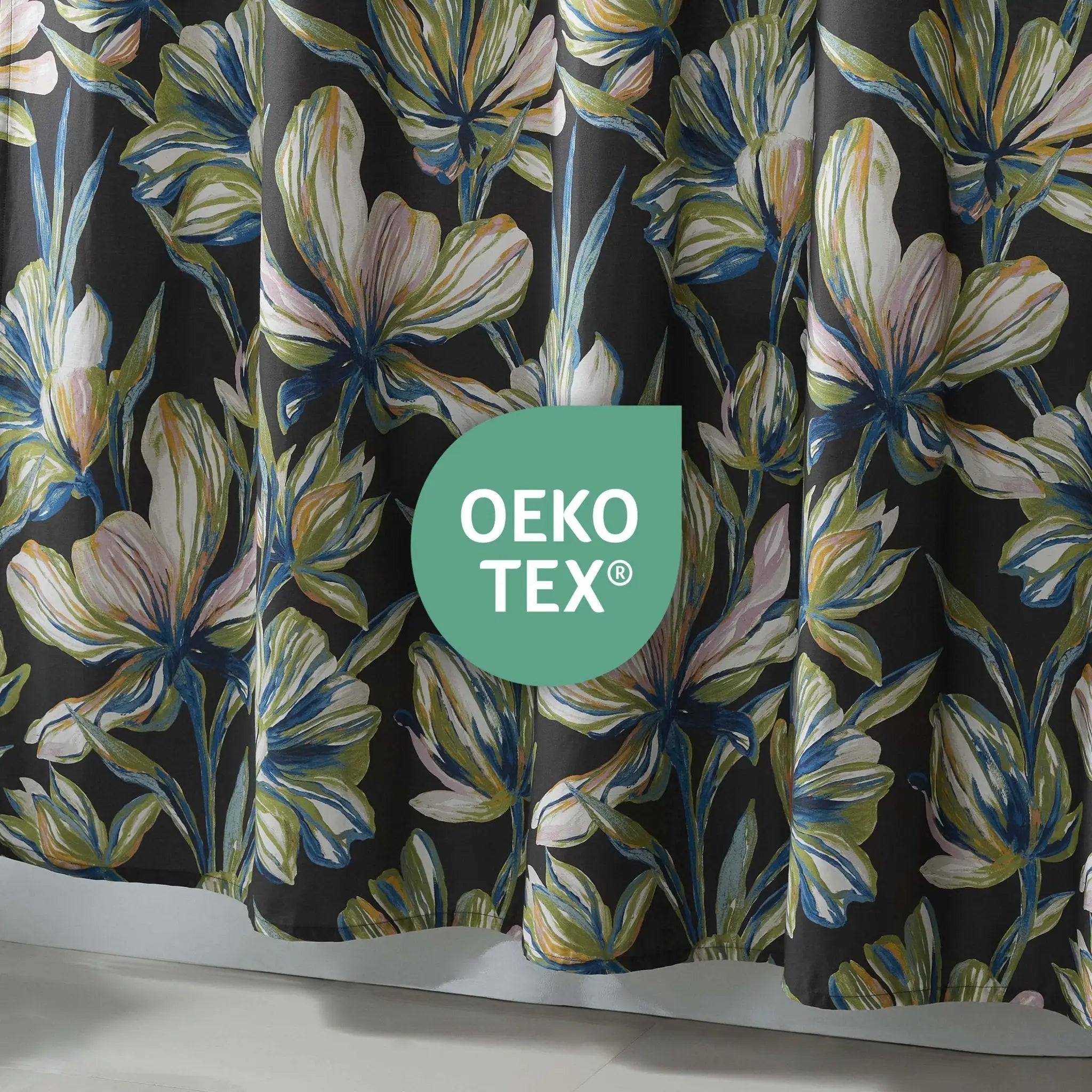 Floral-patterned fabric with OEKO-TEX logo on a dark background