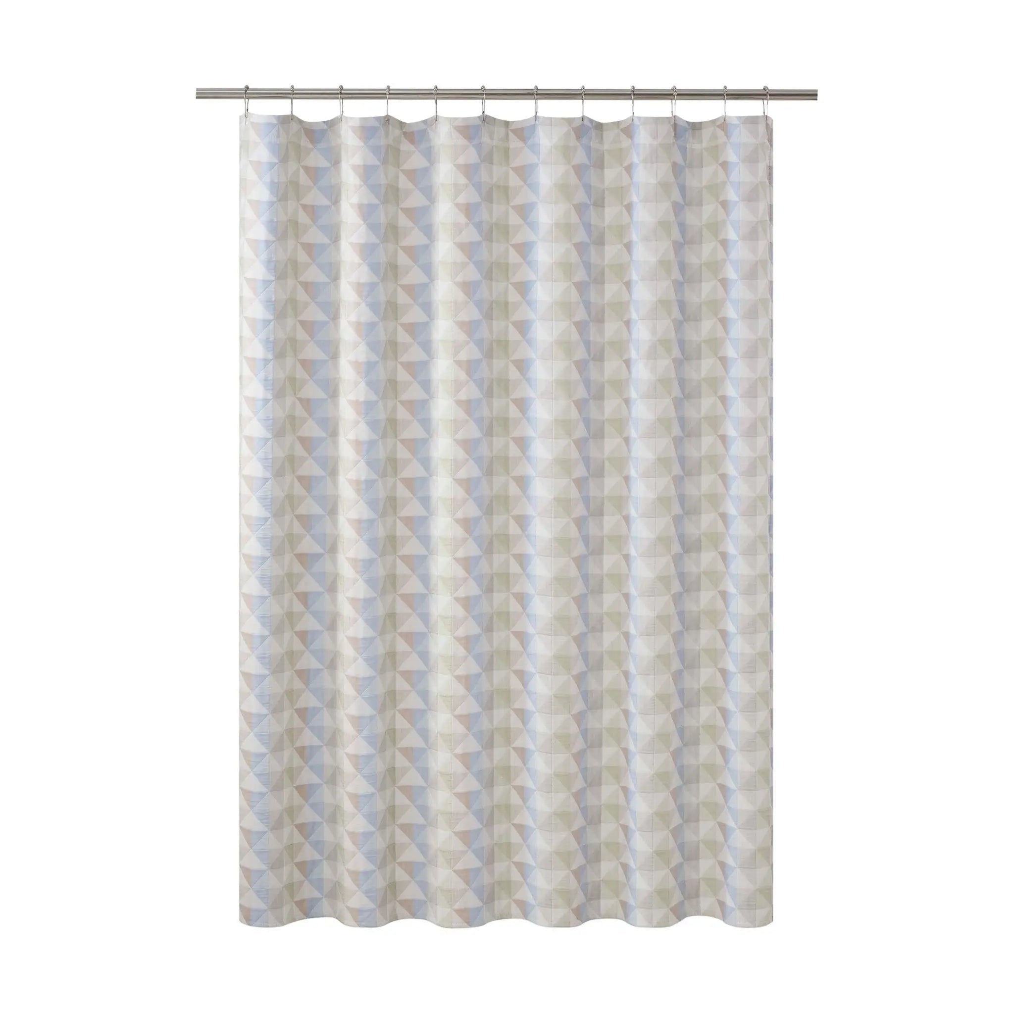 A shower curtain featuring a vertical geometric pattern of triangles in light blue, gray, and cream, hanging from a silver metal rod against a plain white background.