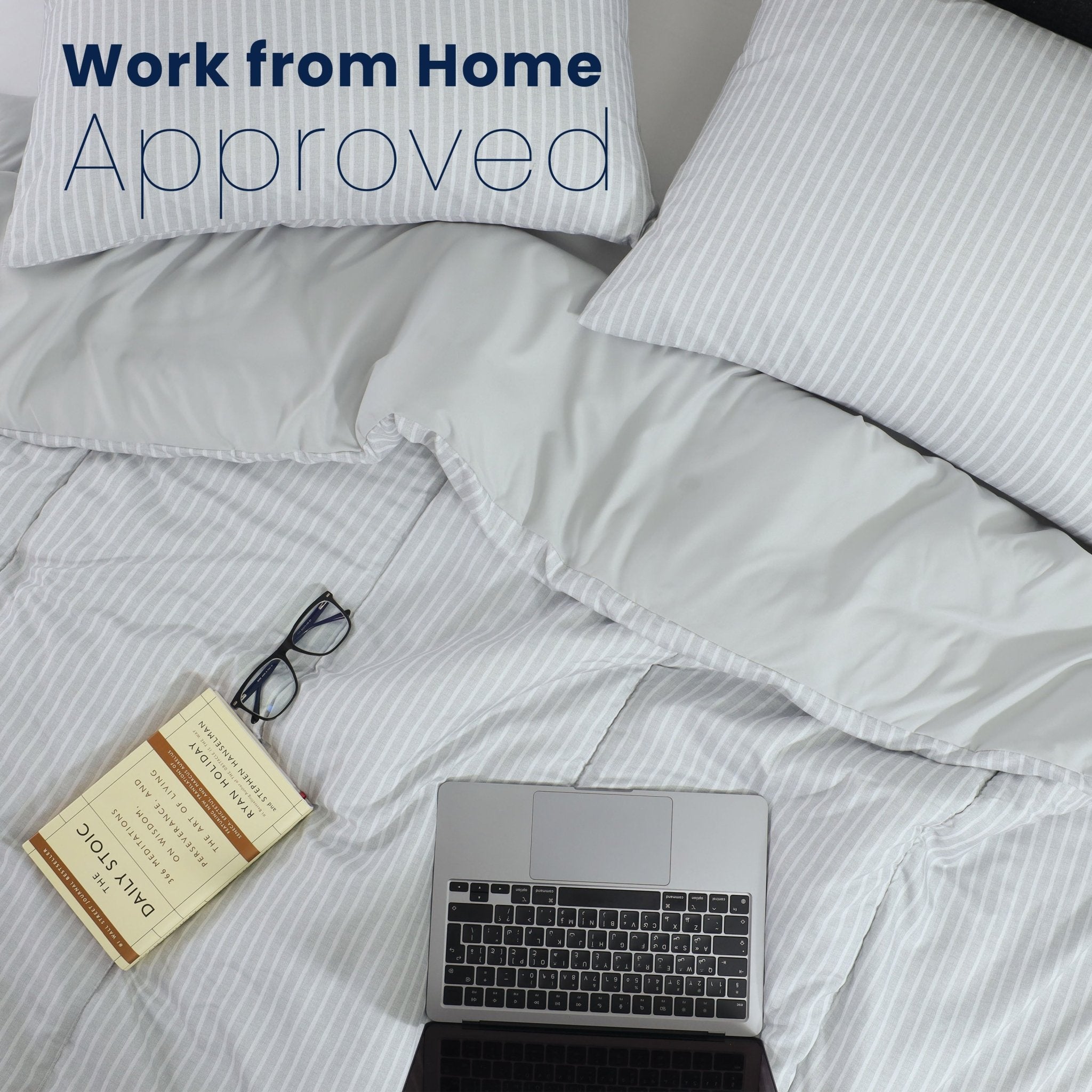 Laptop on a comforter with 'Work from Home Approved' text above
