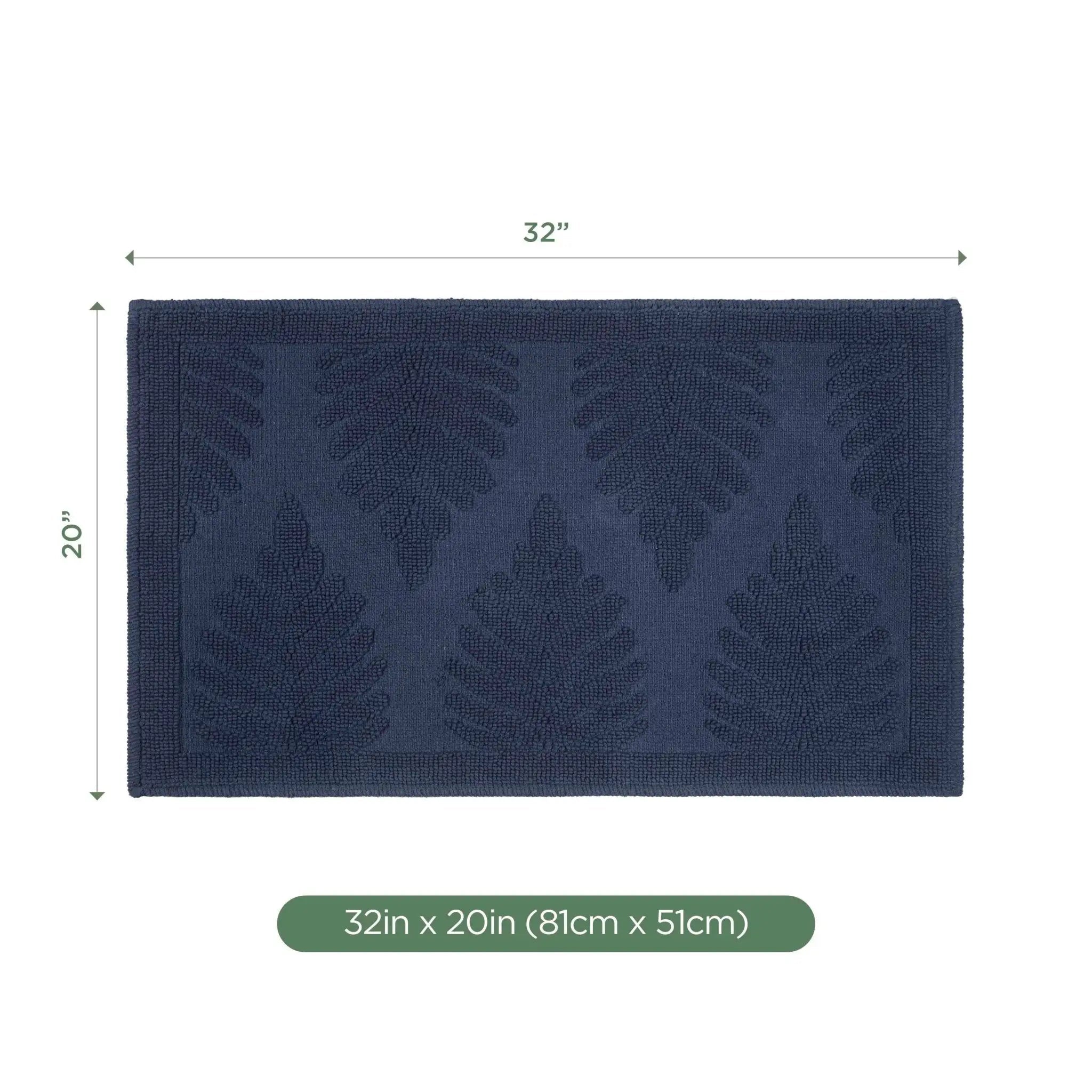 A rectangular navy bath rug with a raised leaf pattern, shown with dimension lines indicating 32 inches by 20 inches, plus a green label at the bottom reading 32in x 20in (81cm x 51cm) on a white background.