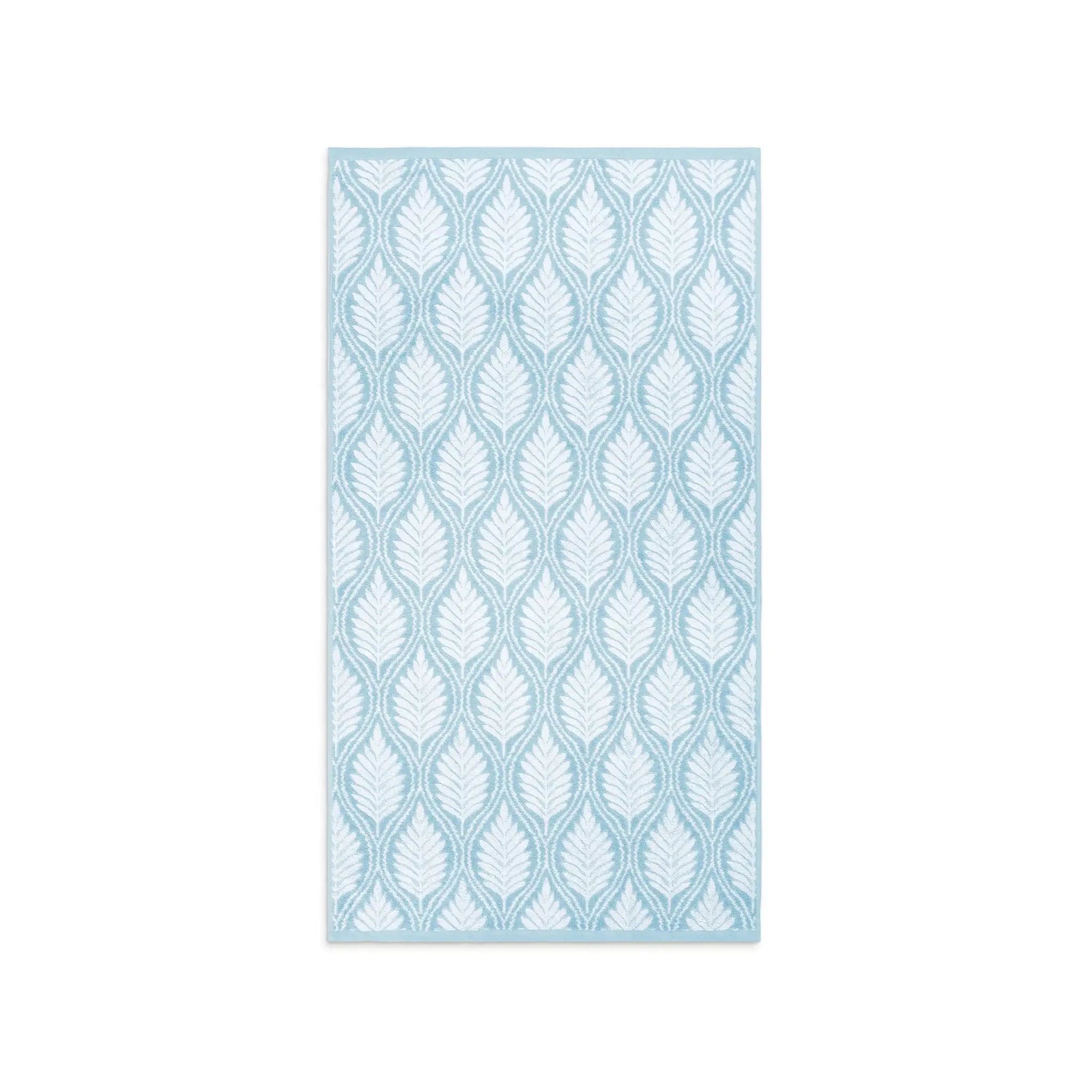 A mineral-colored bath towel with leaf pattern in light blue and white, shown flat against a solid white background.