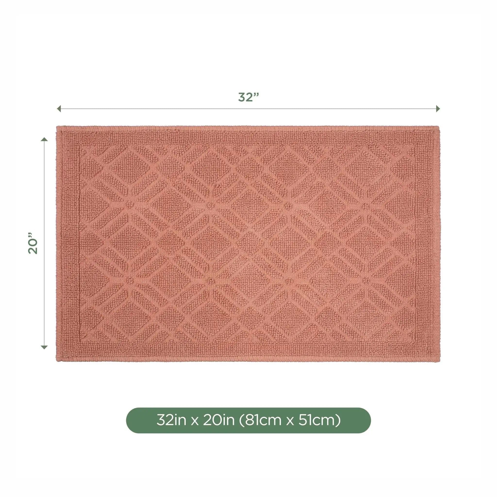 A rectangular bath rug in a clay color with a raised geometric diamond pattern, shown with dimension lines indicating 32 inches by 20 inches on a white background.