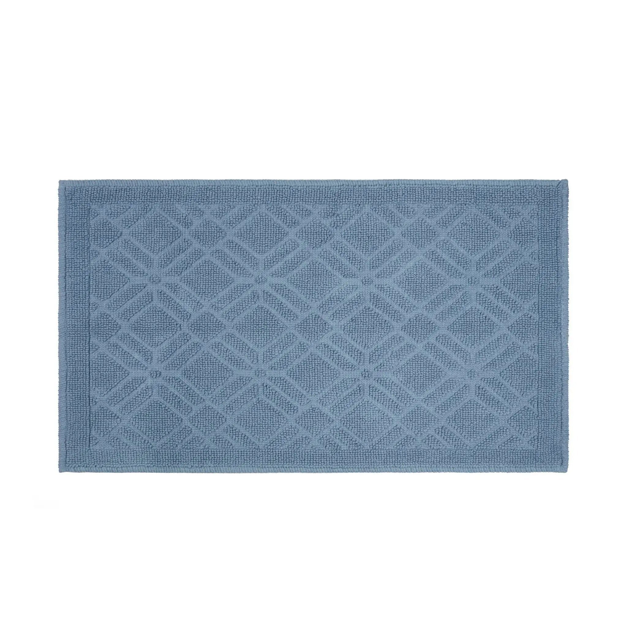 A rectangular blue bath rug with a raised geometric diamond pattern and a solid border, shown flat against a white background.