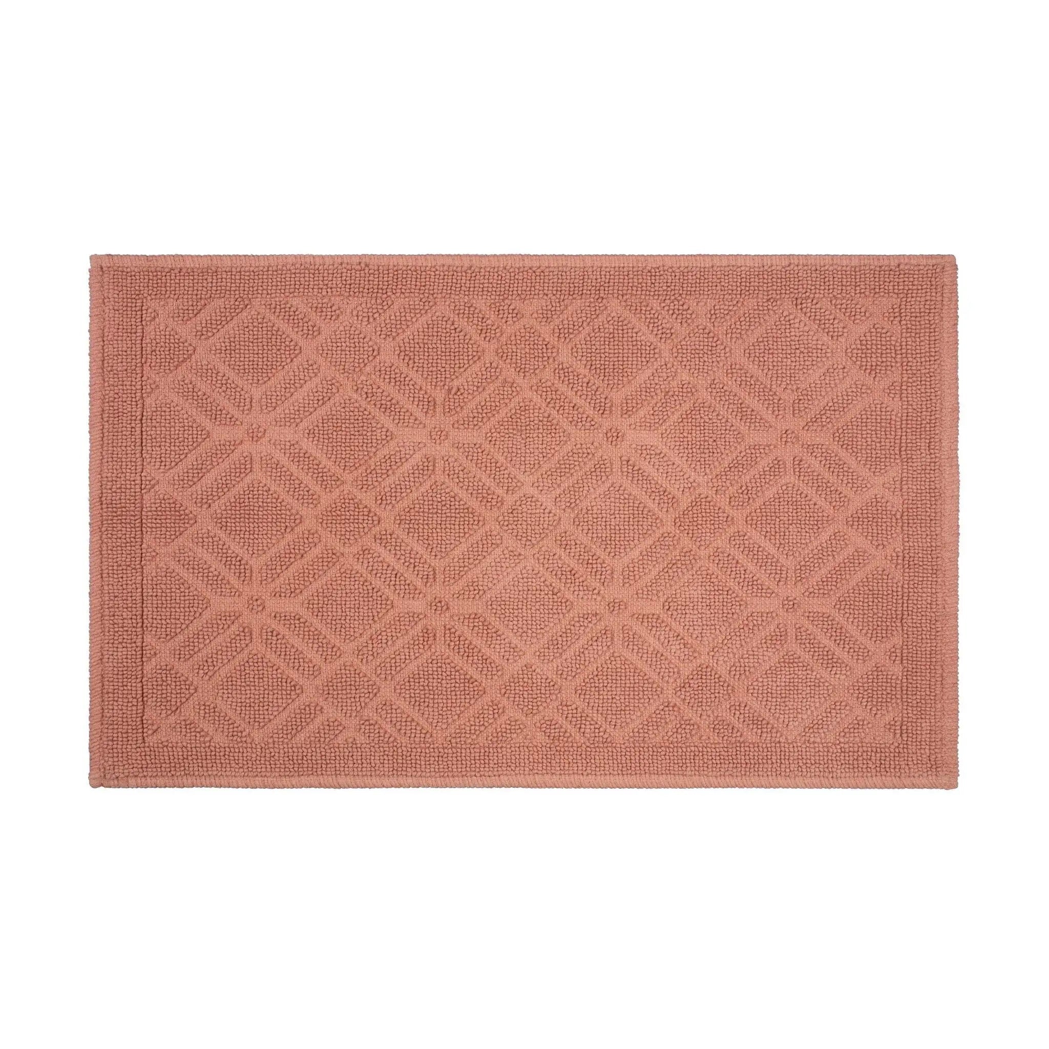 A rectangular clay-colored bath rug with a raised geometric diamond lattice pattern and a matching border, shown flat against a solid white background.