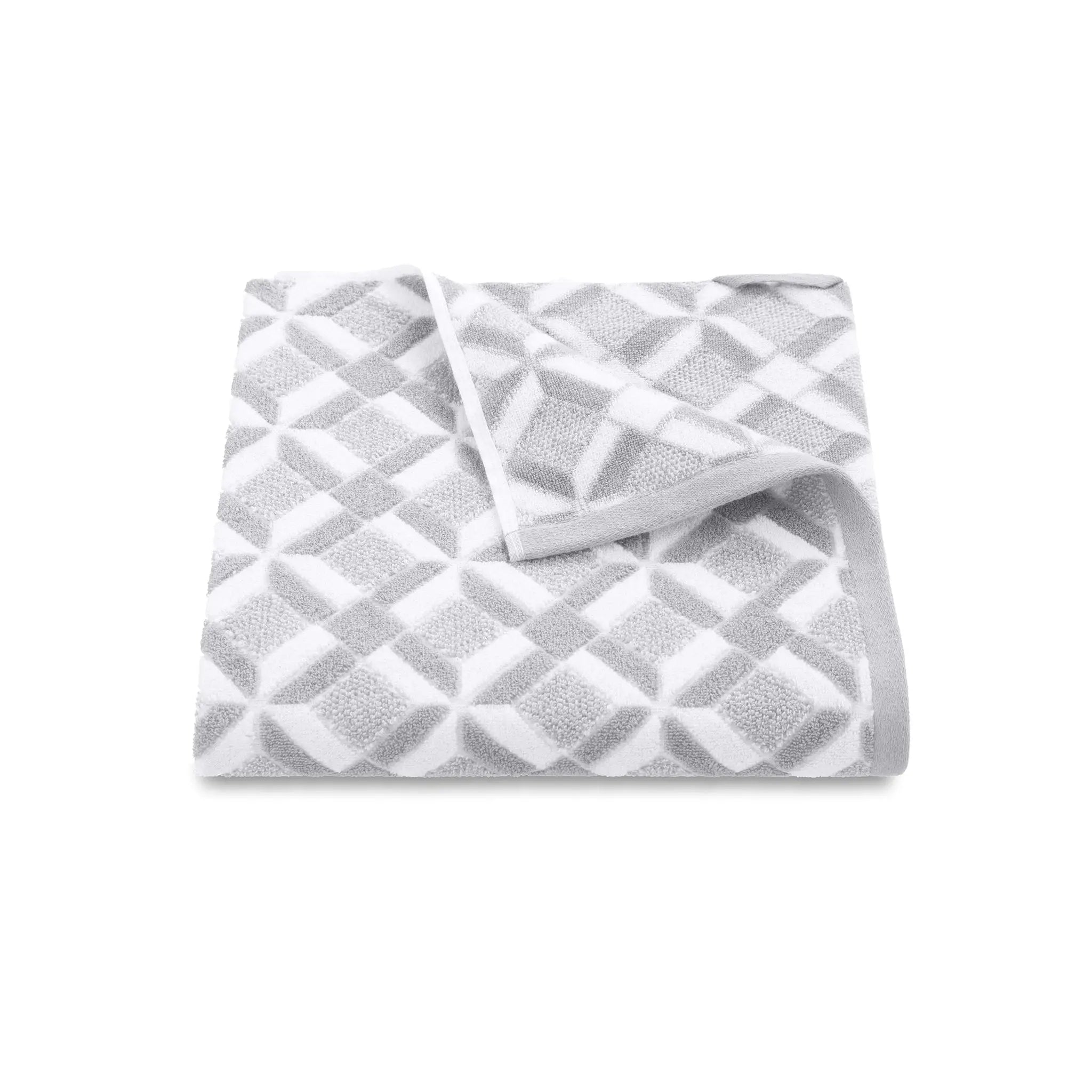 Folded grey patterned bath towel on a white background