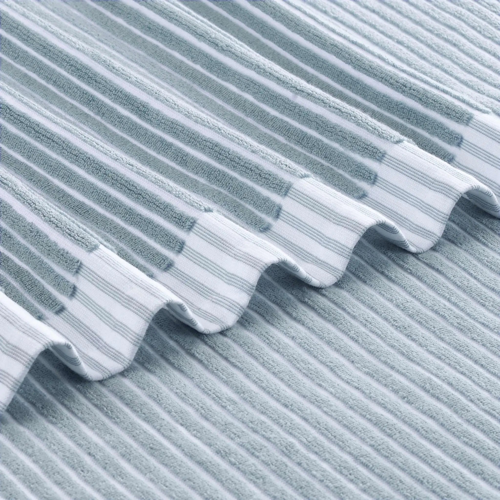 Close-up of a textured blue bath towel surface with wavy pattern