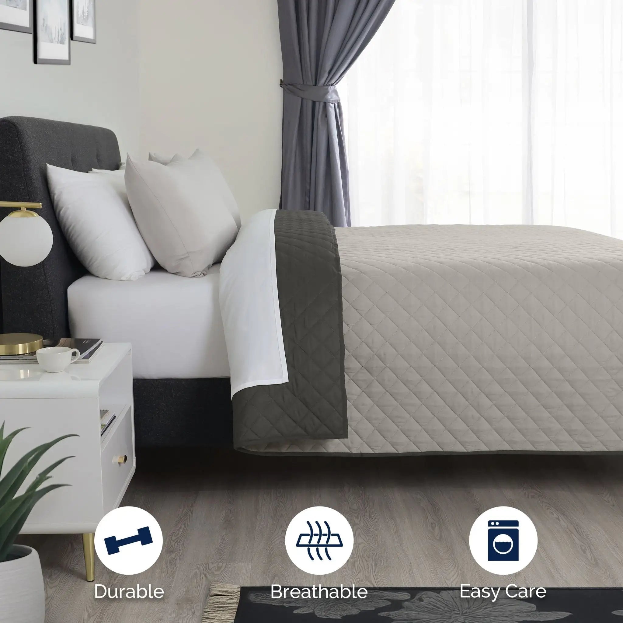 Bed with gray coverlet and graphite folded reversible.