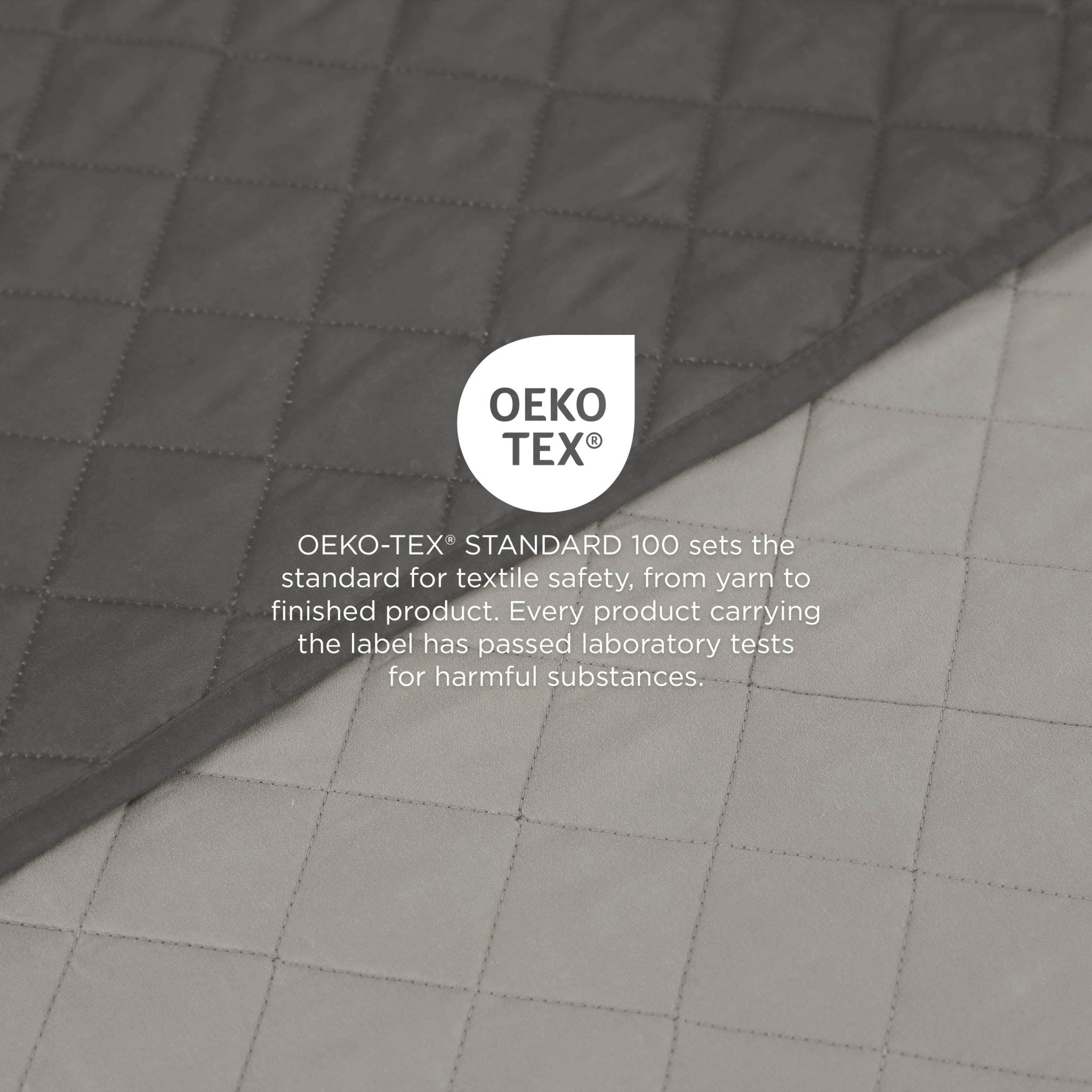 Light gray/graphite coverlet fabric with OEKO-TEX label on a gray background