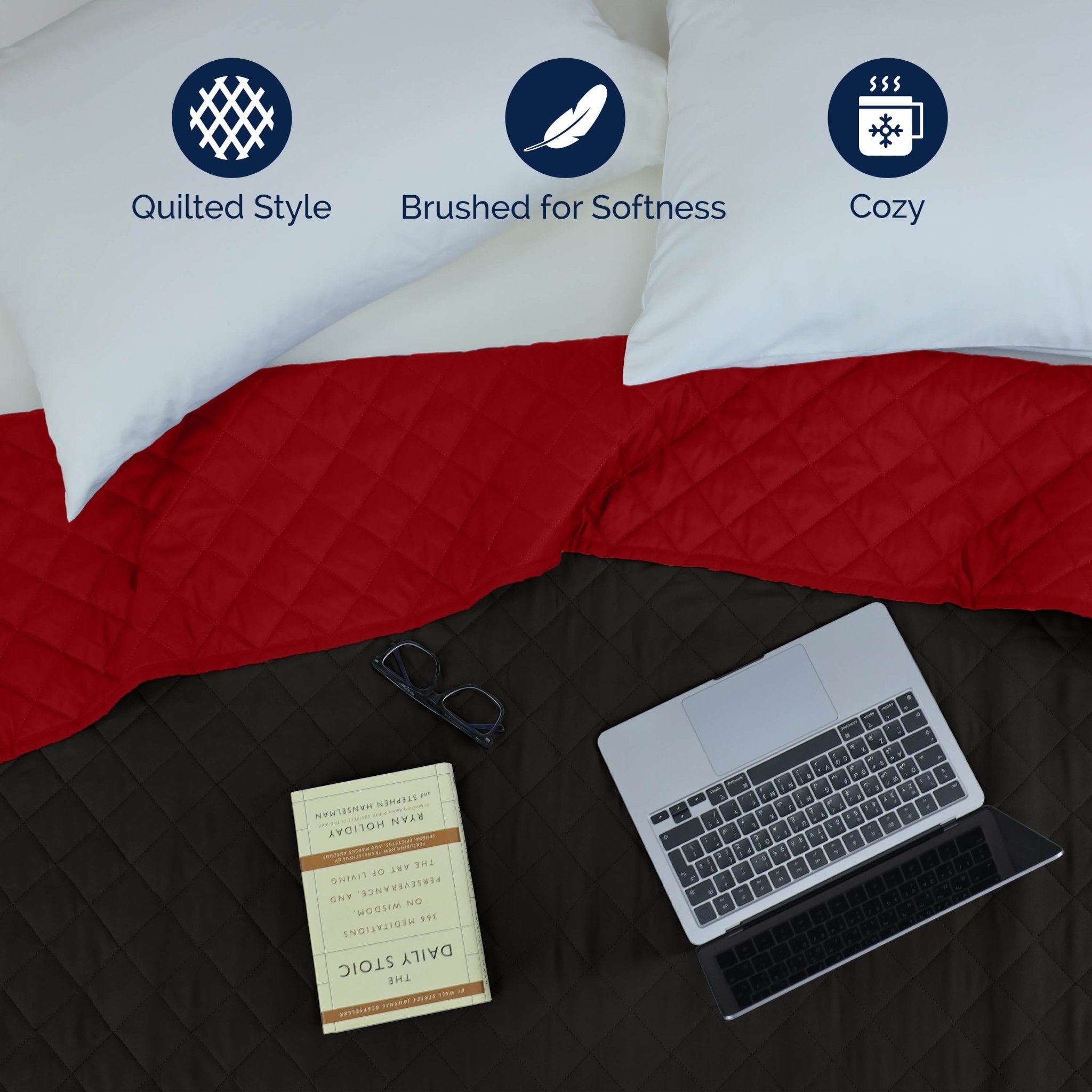 Ebony/red reversible coverlet on a bed with a laptop and book, featuring icons for quilted style, softness, and coziness.
