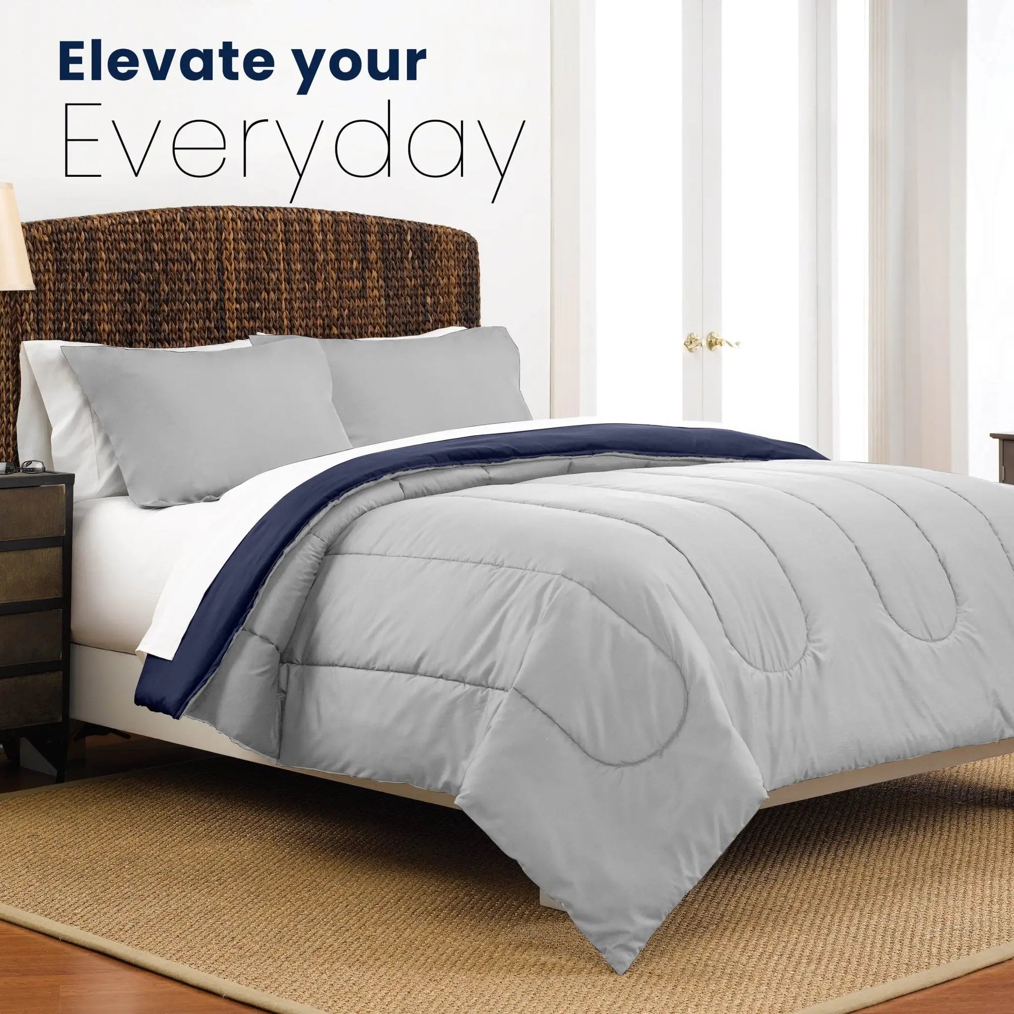 Light gray comforter on a bed with text 'Elevate your Everyday' in a bedroom setting.