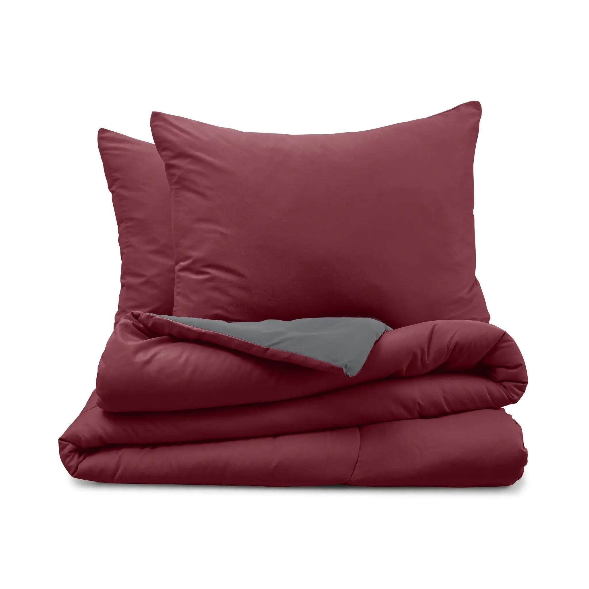 Burgundy comforter set with gray reversible side on a white background