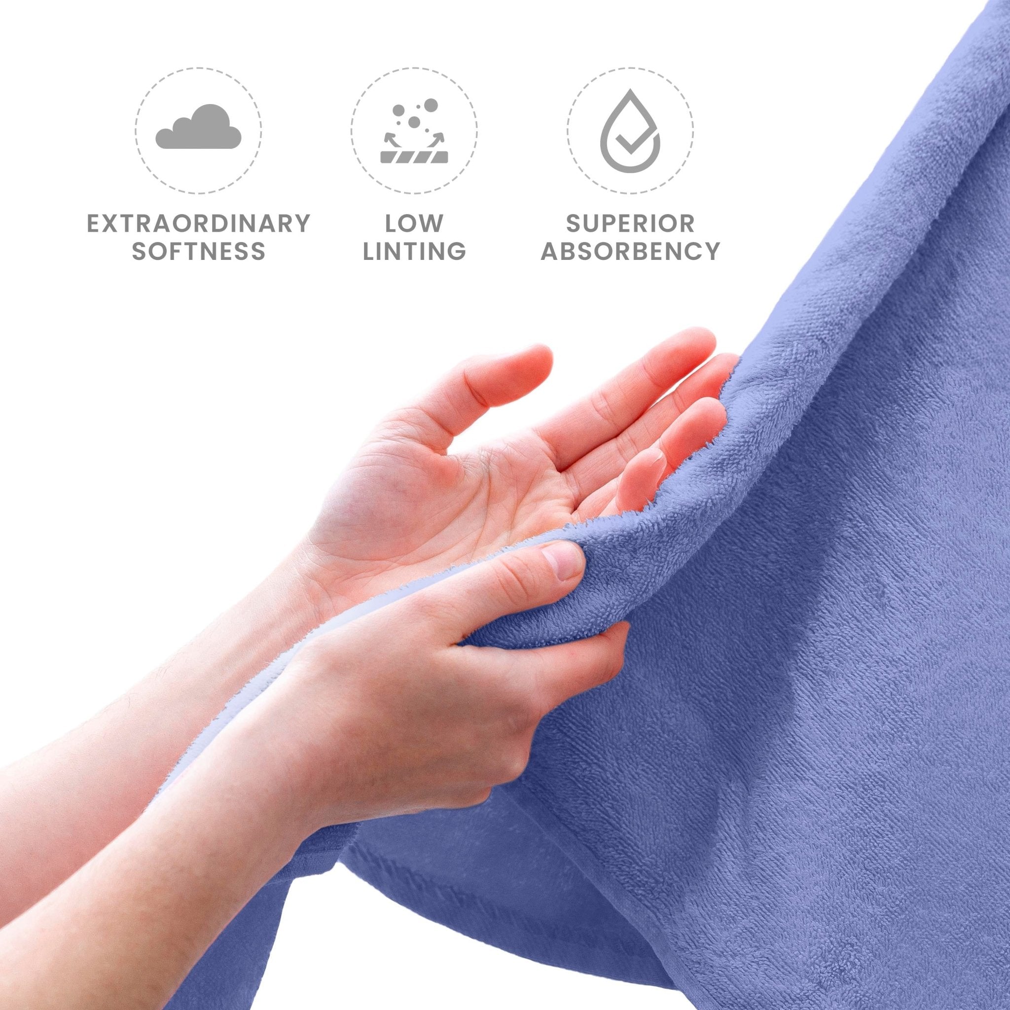 Lavender towel held by hands with text labels for softness, linting, and absorbency on a white background