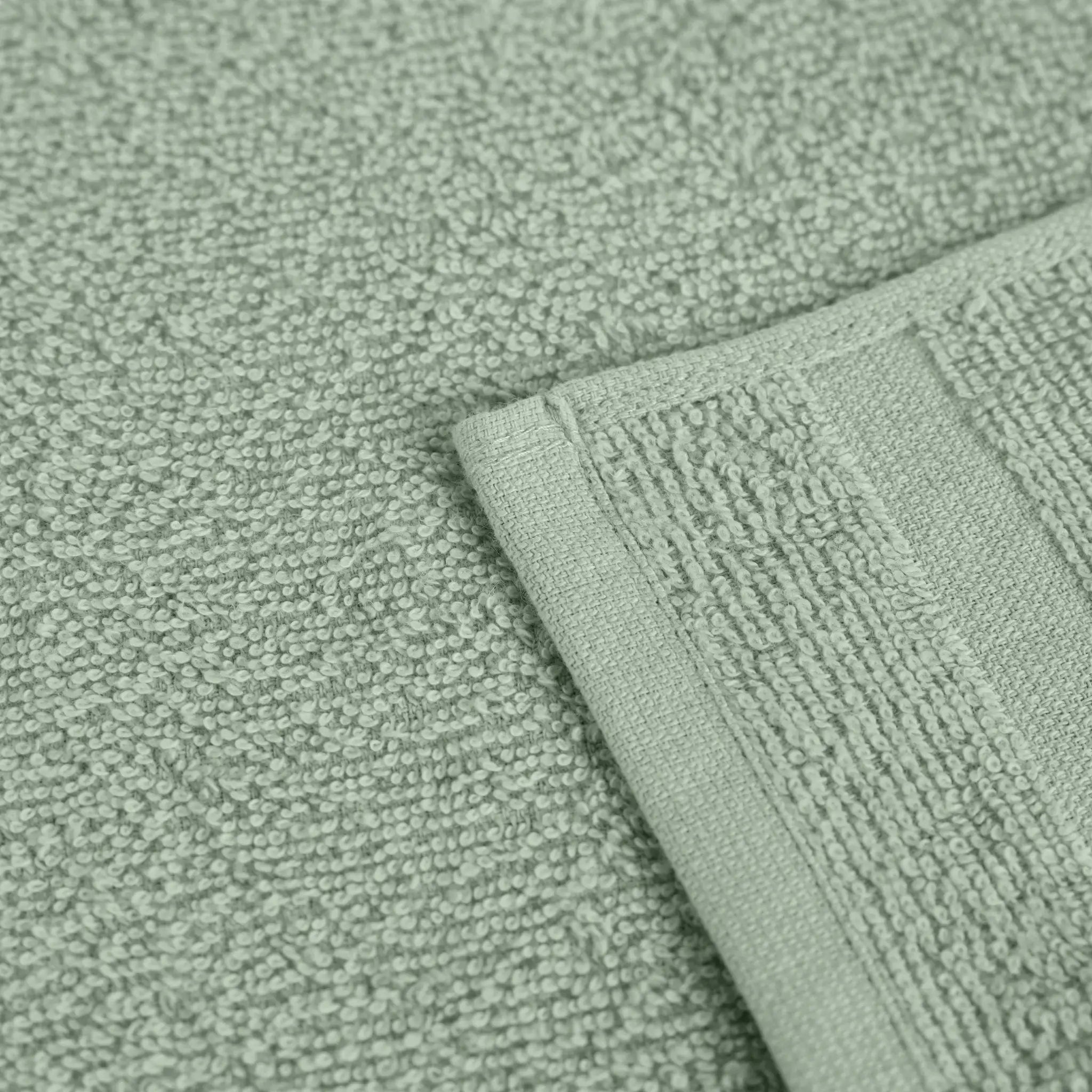 Close-up of textured sage fabric with a folded corner