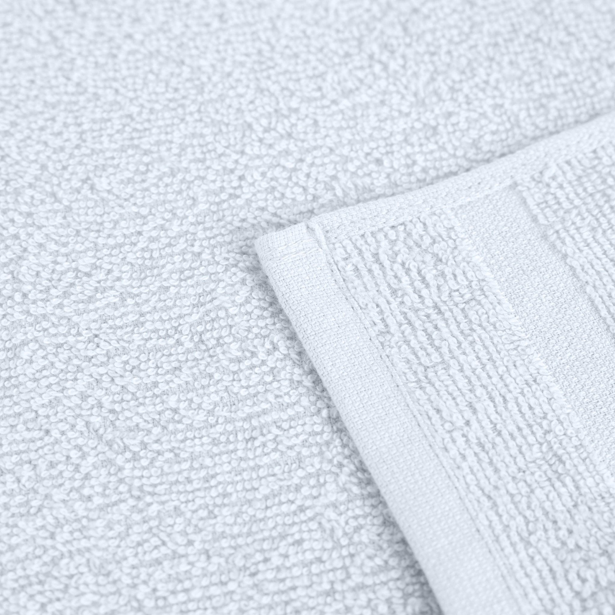 Close-up of a textured white fabric with a folded corner.