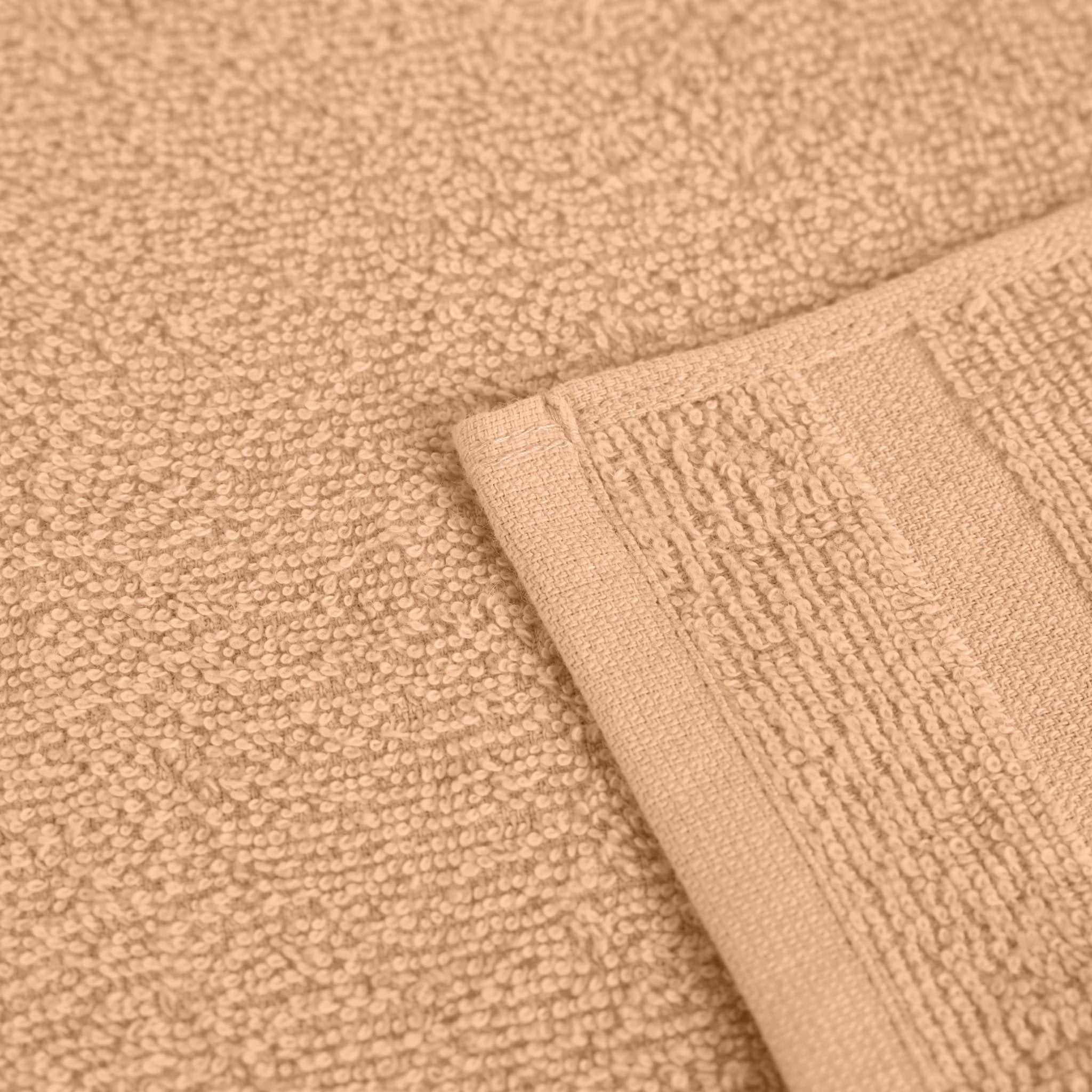 Close-up of a textured peach fabric with a folded edge