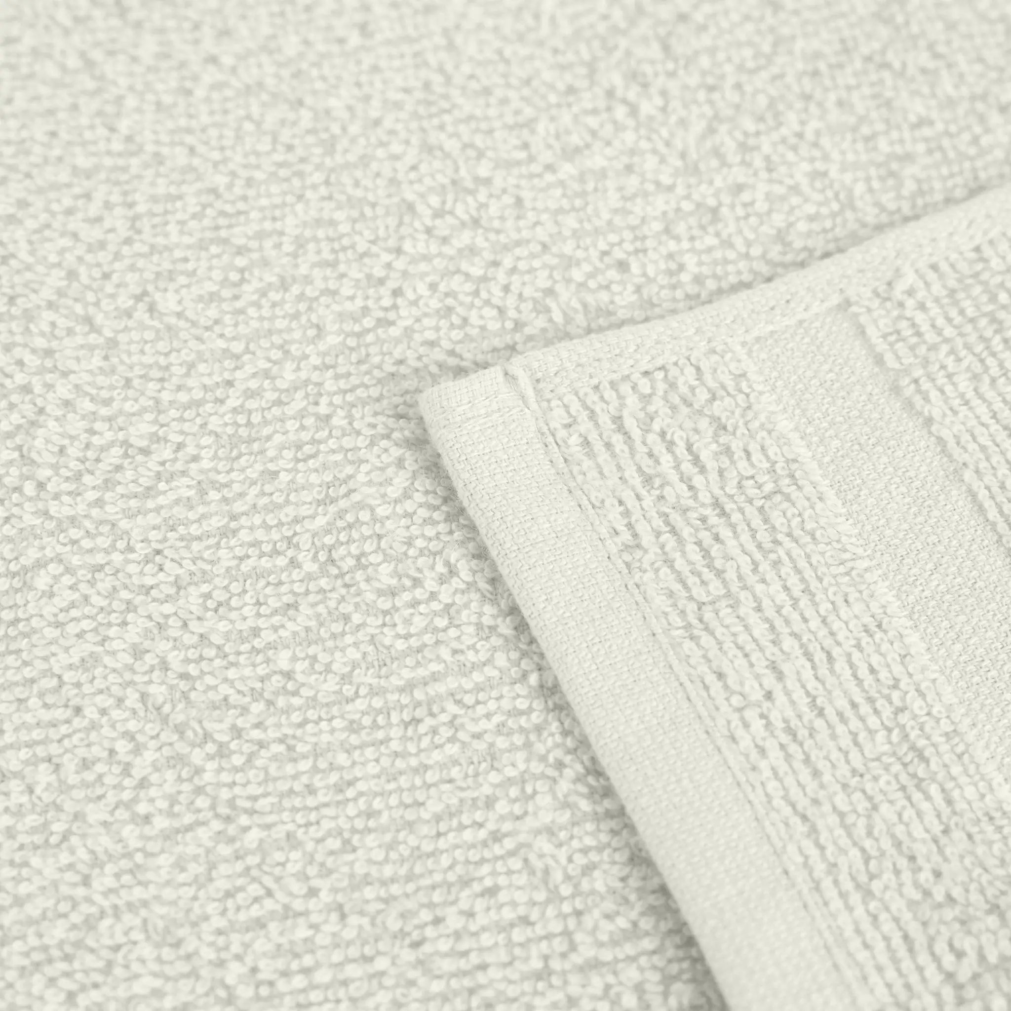 Close-up of textured ivory fabric with a folded corner