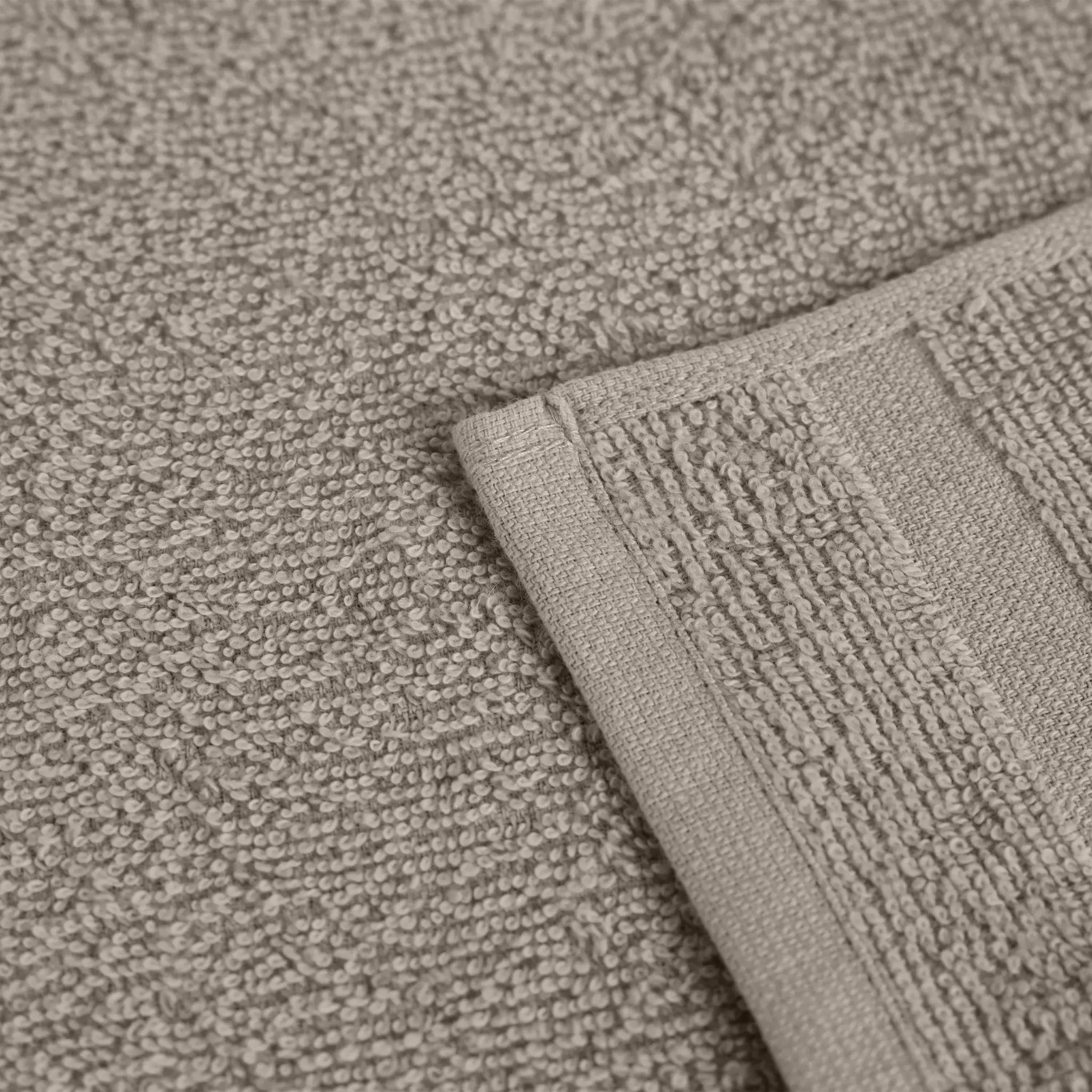 Close-up of a textured beige fabric with a folded edge