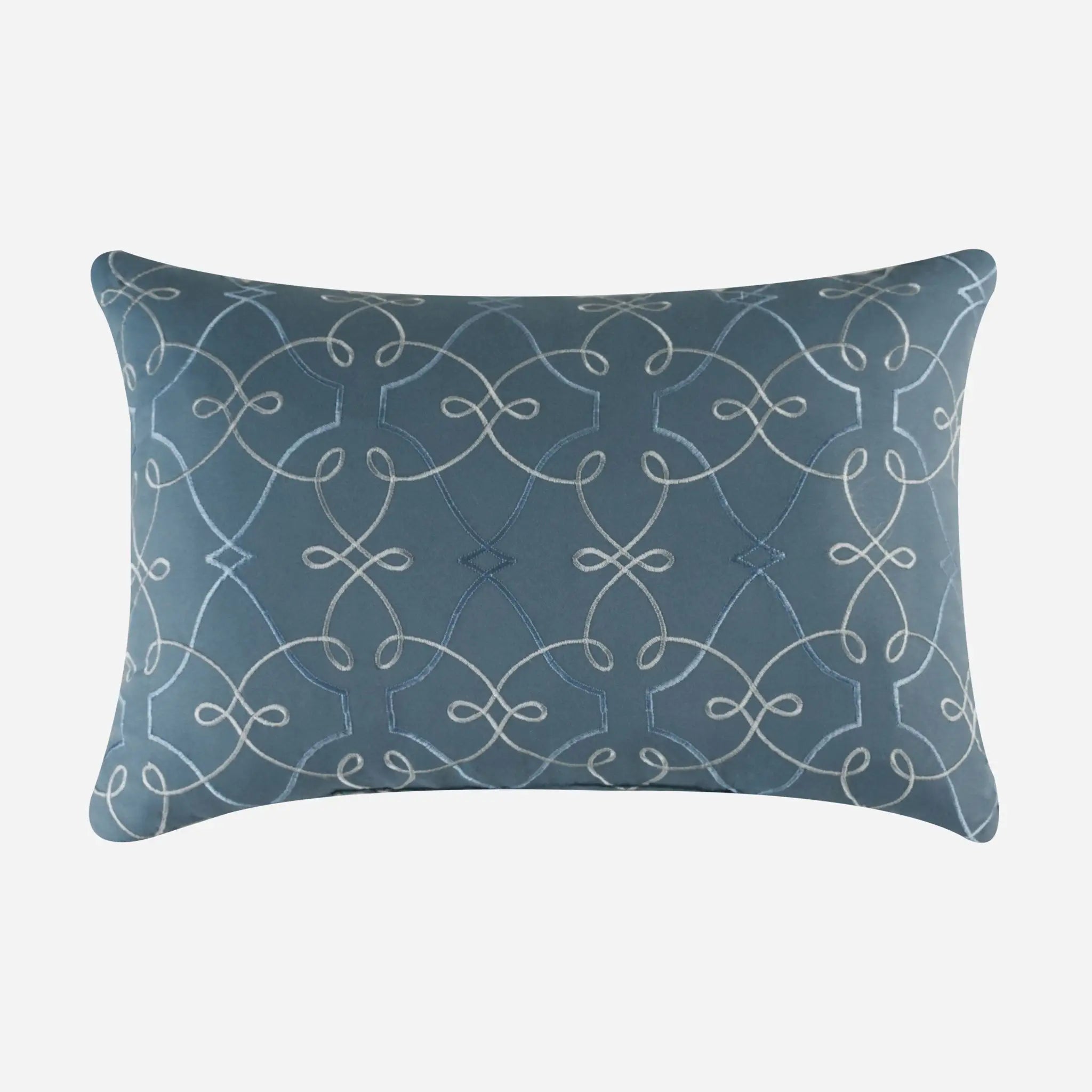Blue pillow with white geometric pattern on a white background