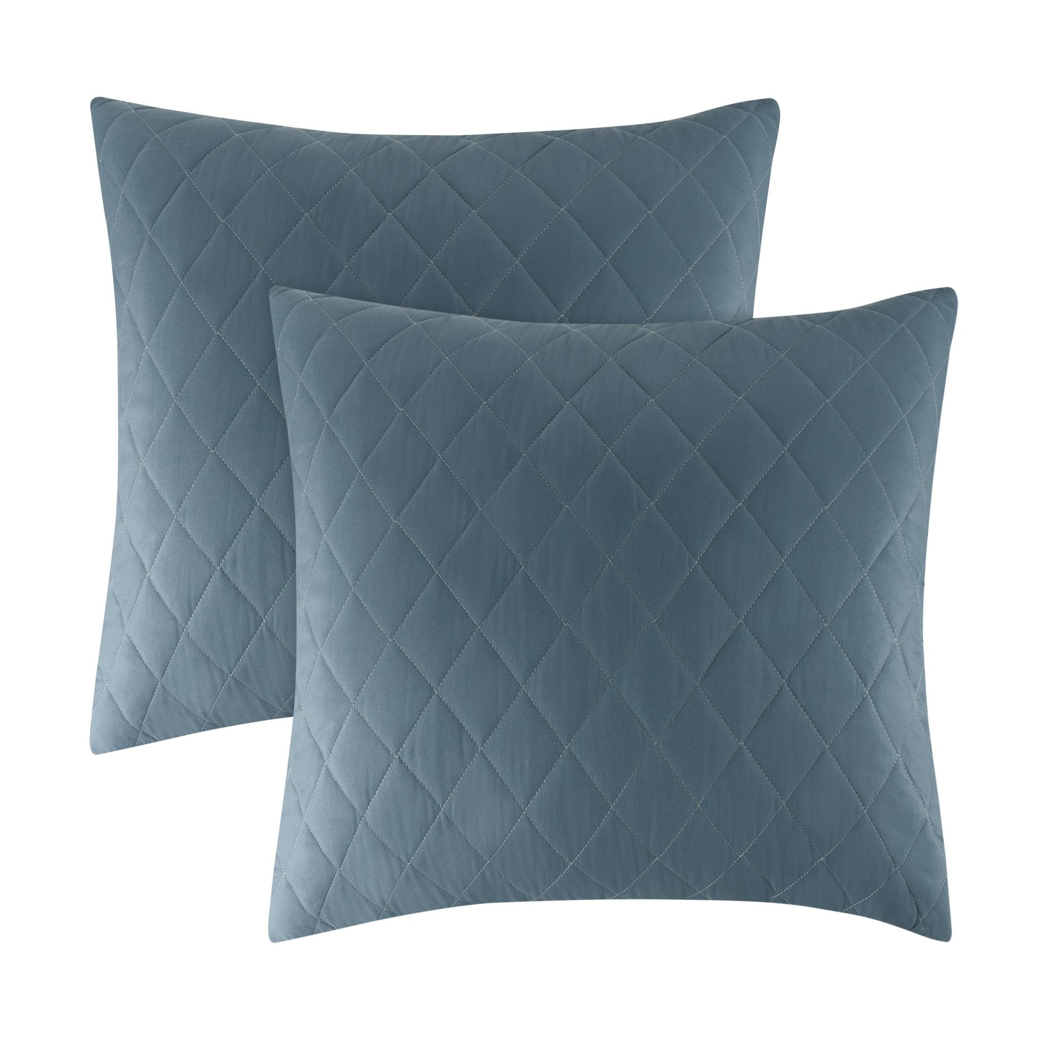 Two blue quilted pillows on a white background