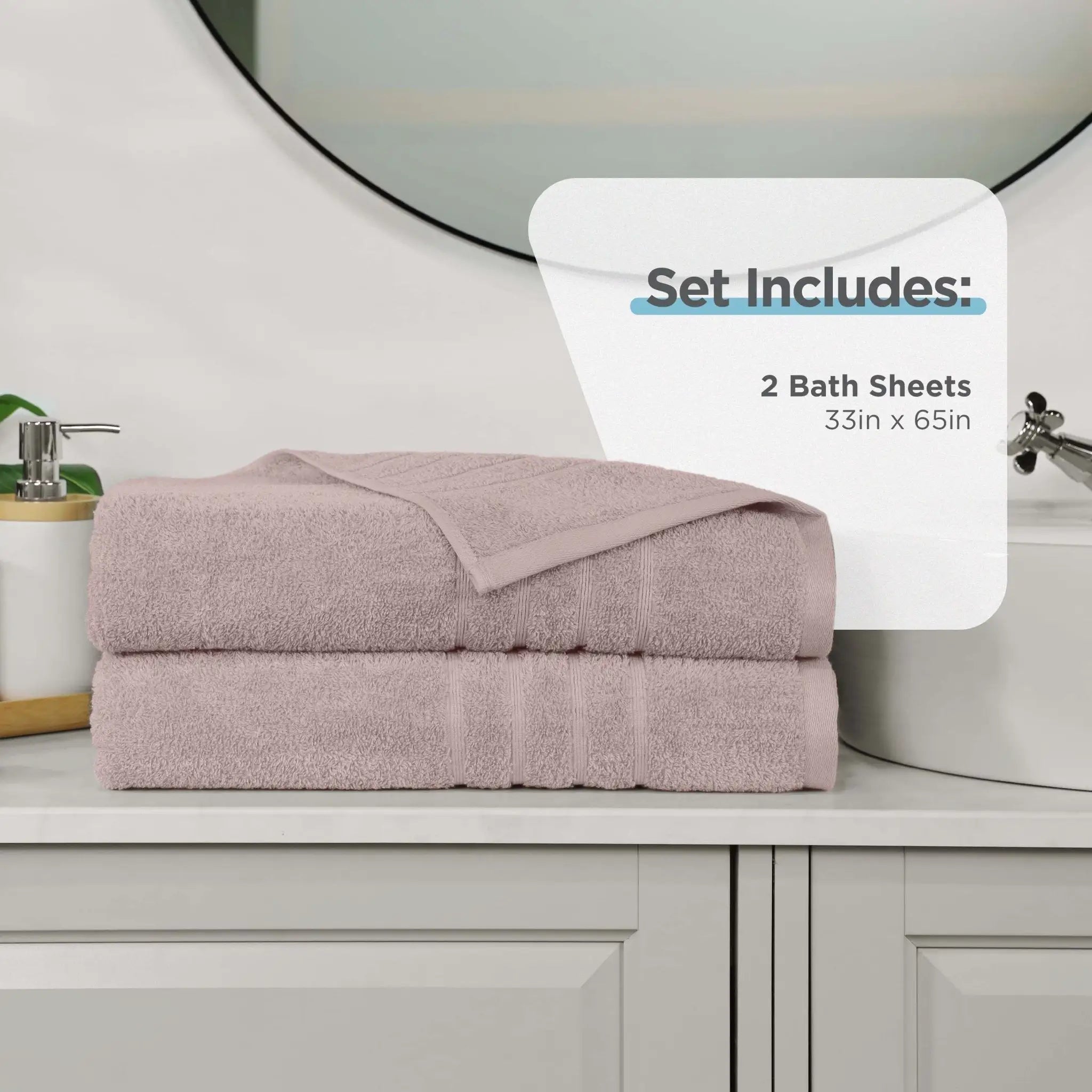 A set of two folded bath sheets in a pink color, stacked on a bathroom counter. A white graphic overlay on the right reads 'Set Includes: 2 Bath Sheets 33in x 65in'.