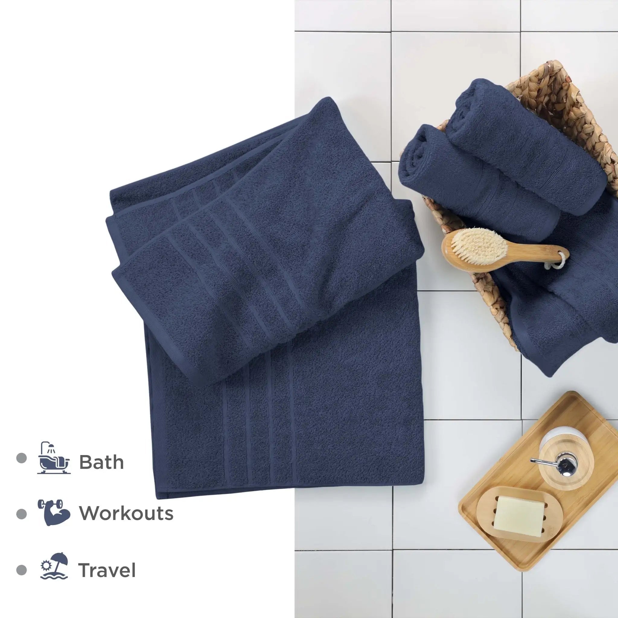 Estate blue bath sheets on a tiled floor with bath accessories.