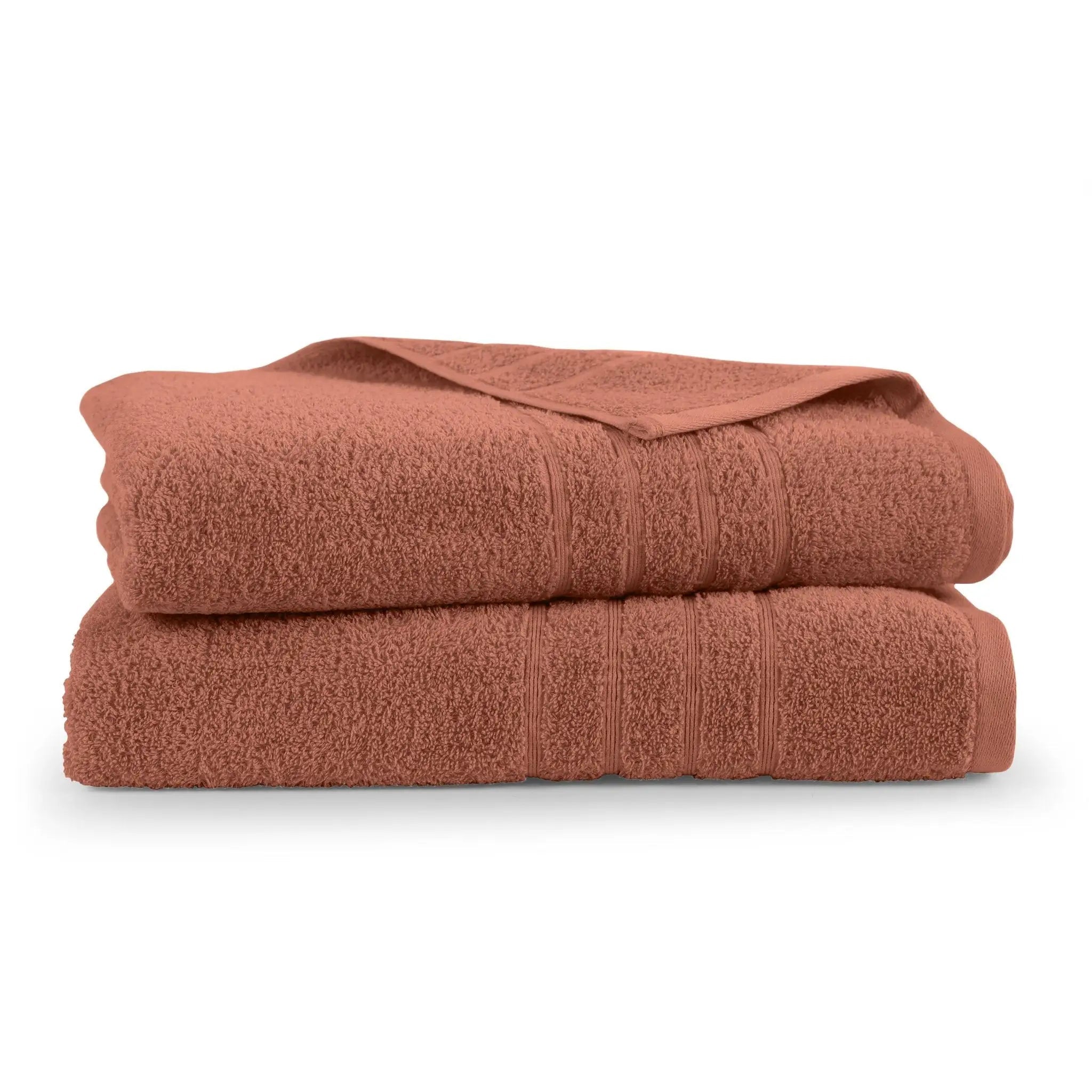 A stack of two terracotta-colored cotton bath sheets shown on a clean white background.
