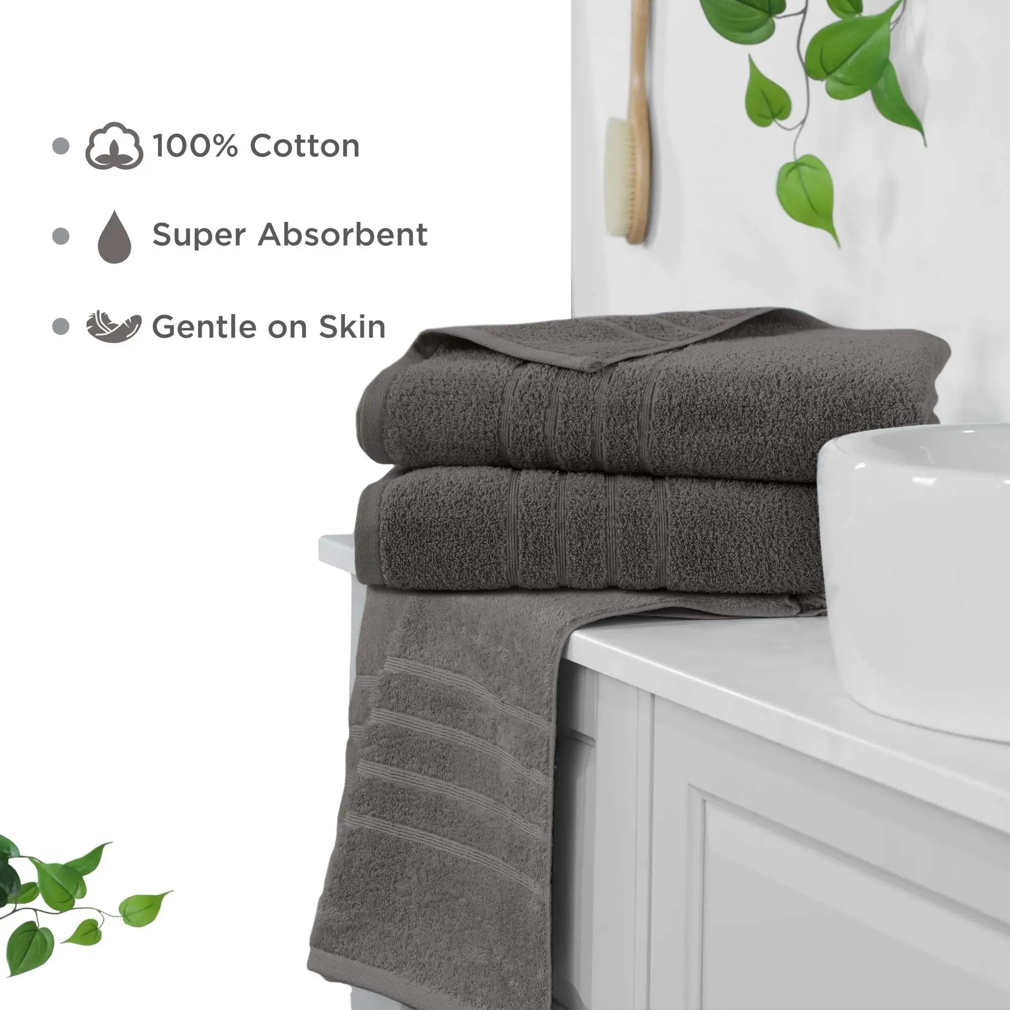 two folded dark gray cotton bath sheets stacked on a white bathroom vanity, with text callouts stating 100% Cotton, Super Absorbent, and Gentle on Skin.