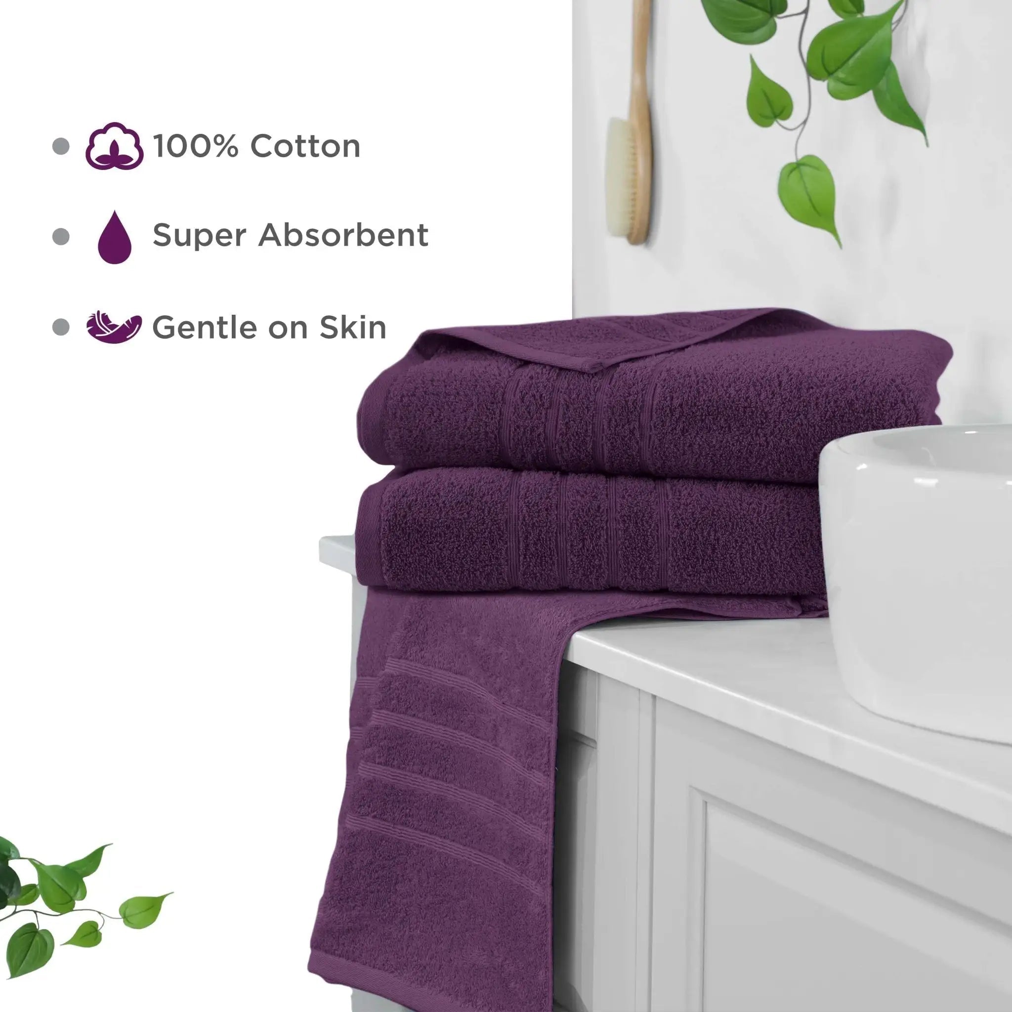Purple bath sheets on a white cabinet with green leaves in the background