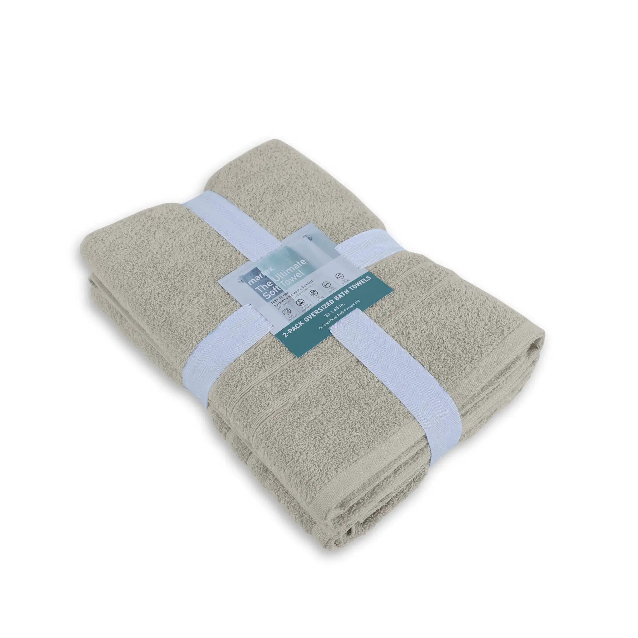 Folded sand-colored bath sheets with a label on a white background