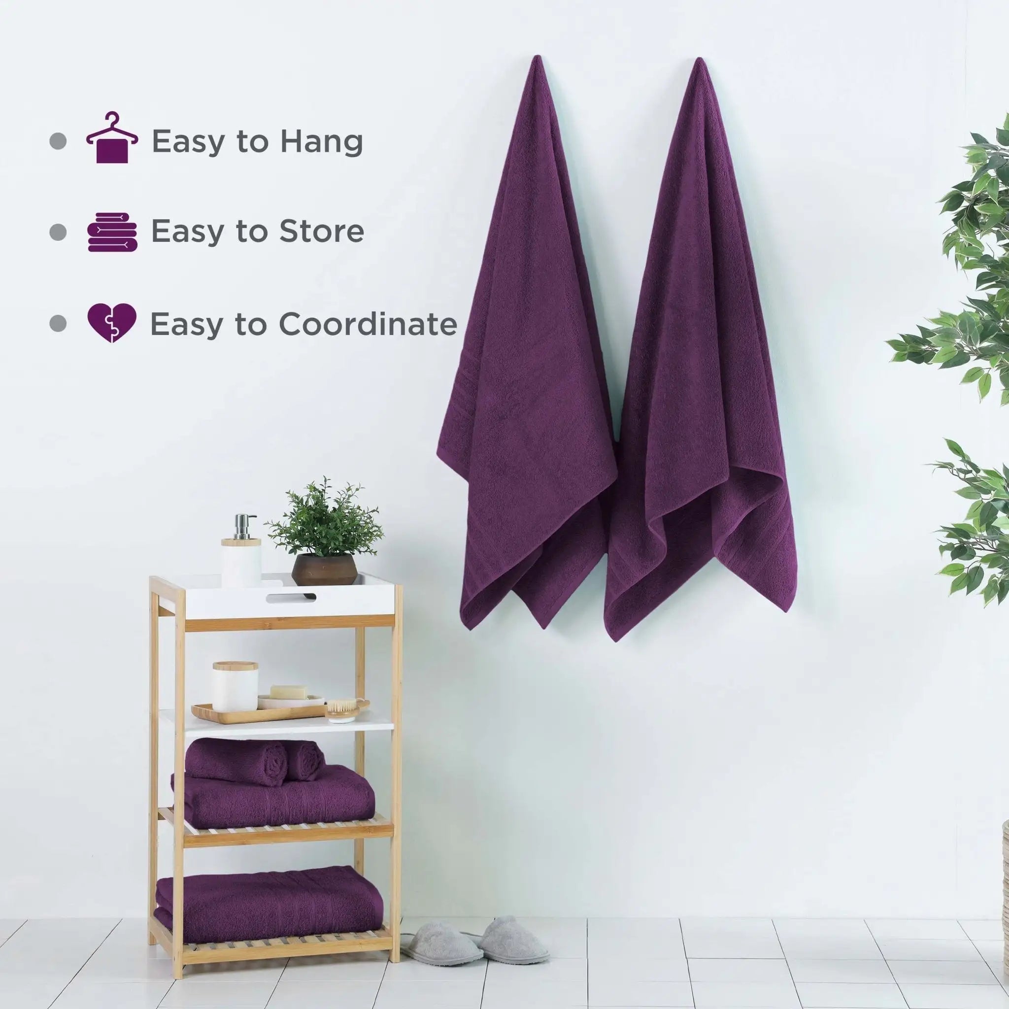 Purple bath sheets hanging on a wall with a wooden shelf below, featuring text about towel features.