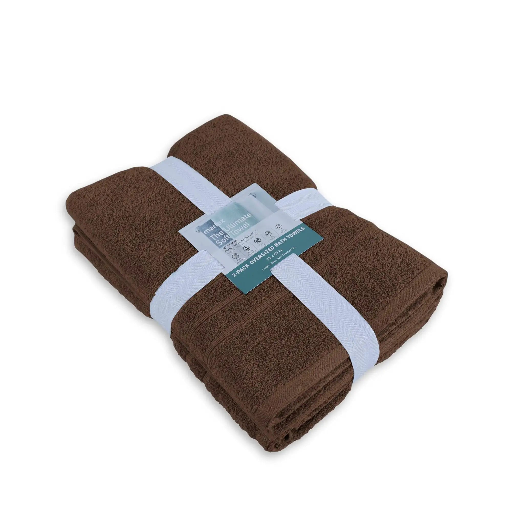 Folded chocolate colored bath sheet with a label on a white background