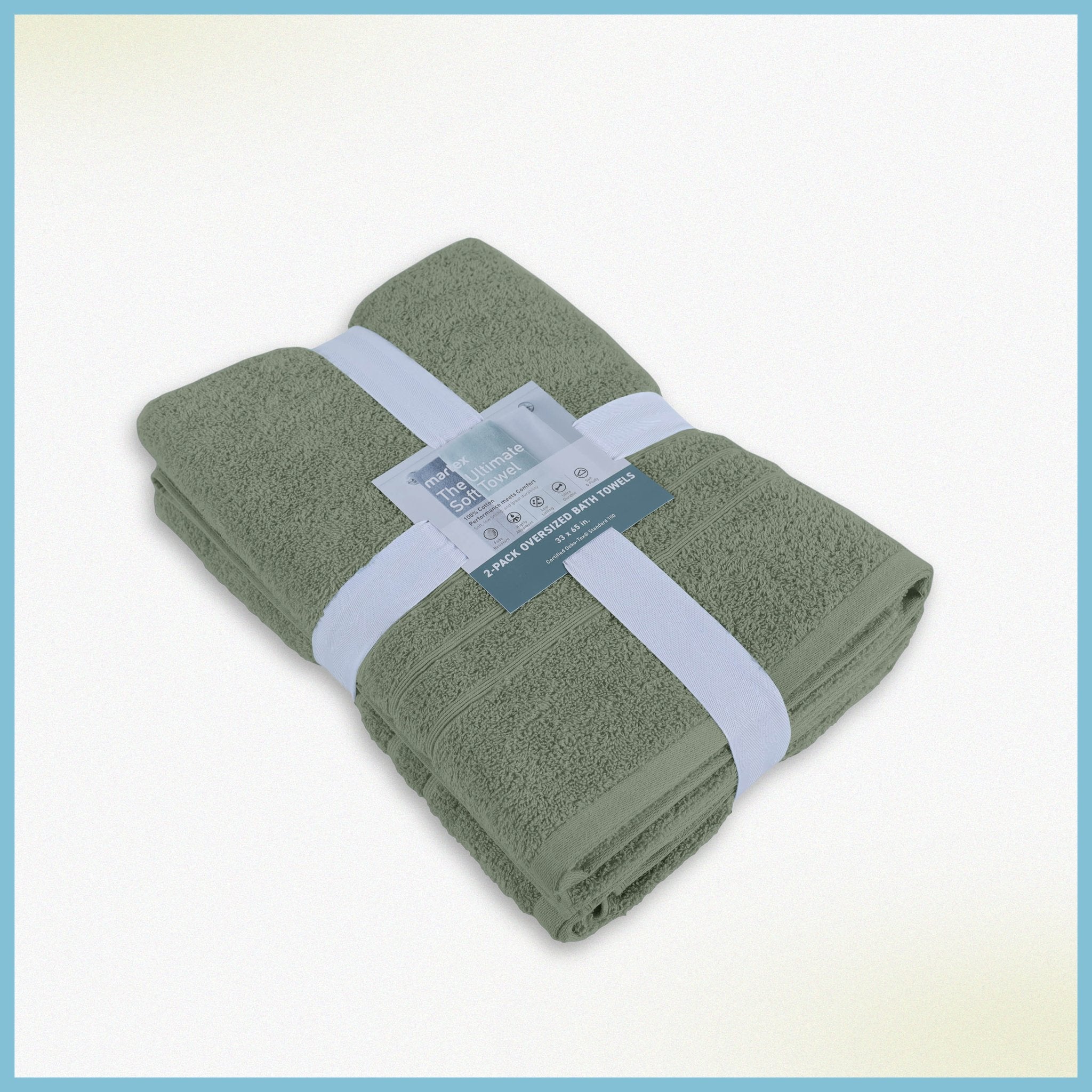 Folded sage bath sheets with a label on a white background