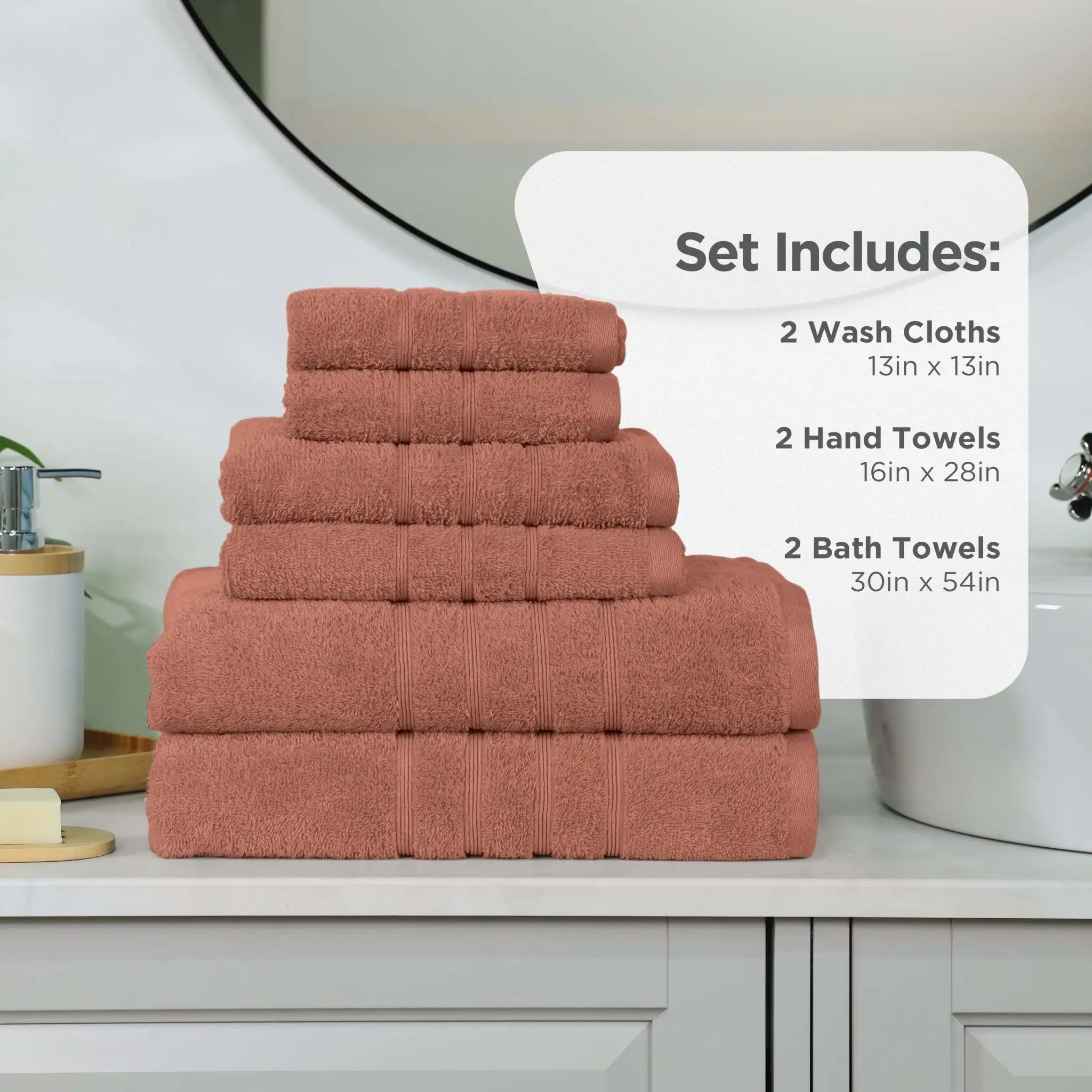A set of terracotta-colored towels stacked on a bathroom counter, with an informational overlay detailing the included sizes and counts: 2 wash cloths, 2 hand towels, and 2 bath towels.