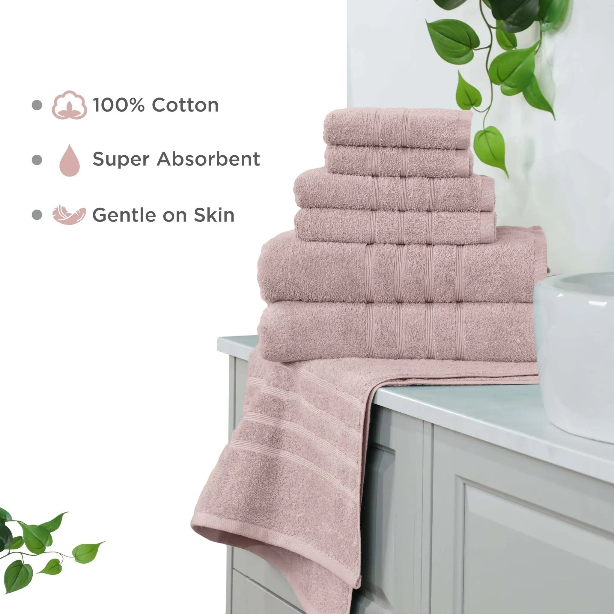 Stack of pink towel set on a bathroom counter with text highlighting features.