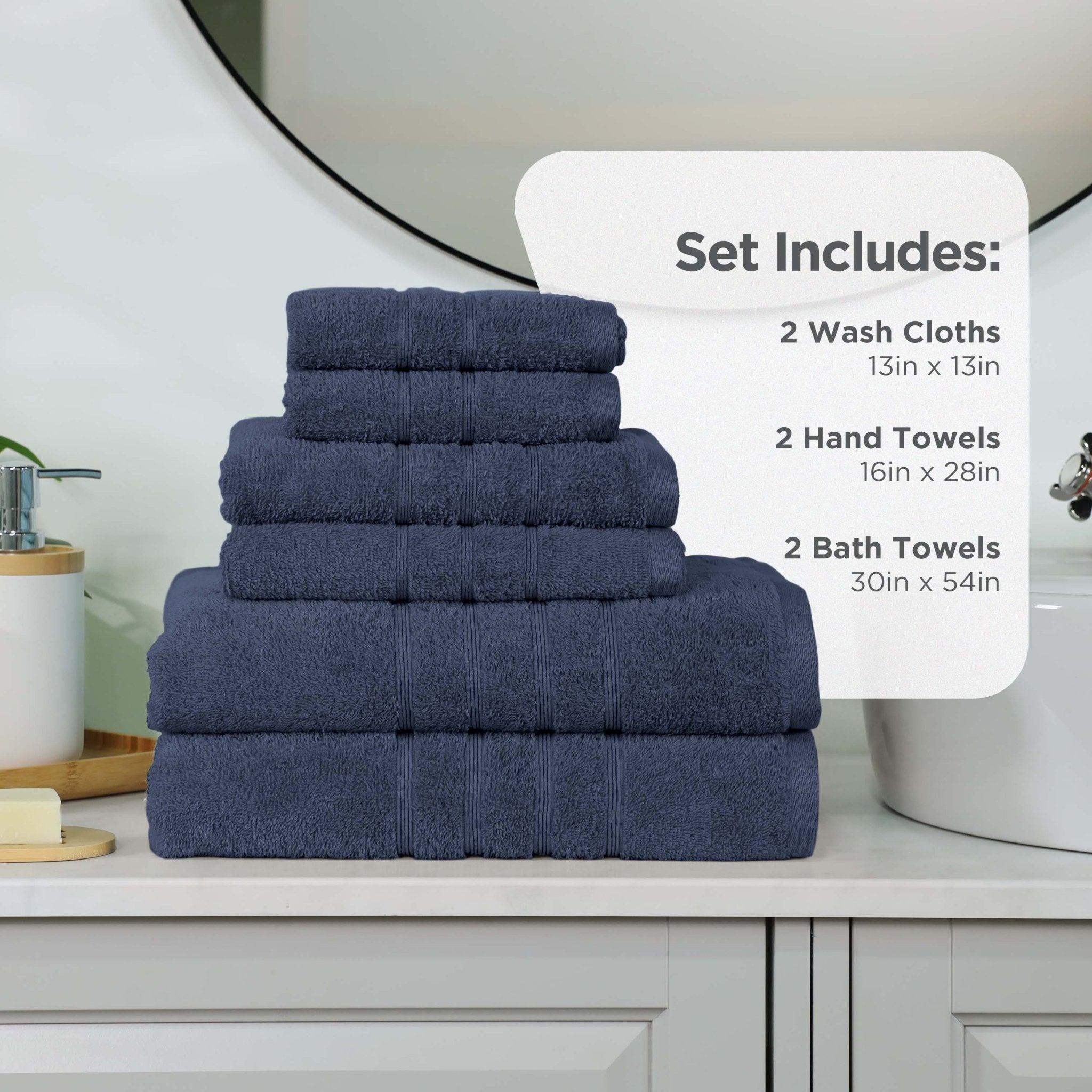 Set of estate blue towels including washcloths, hand towels, and bath towels on a bathroom counter.