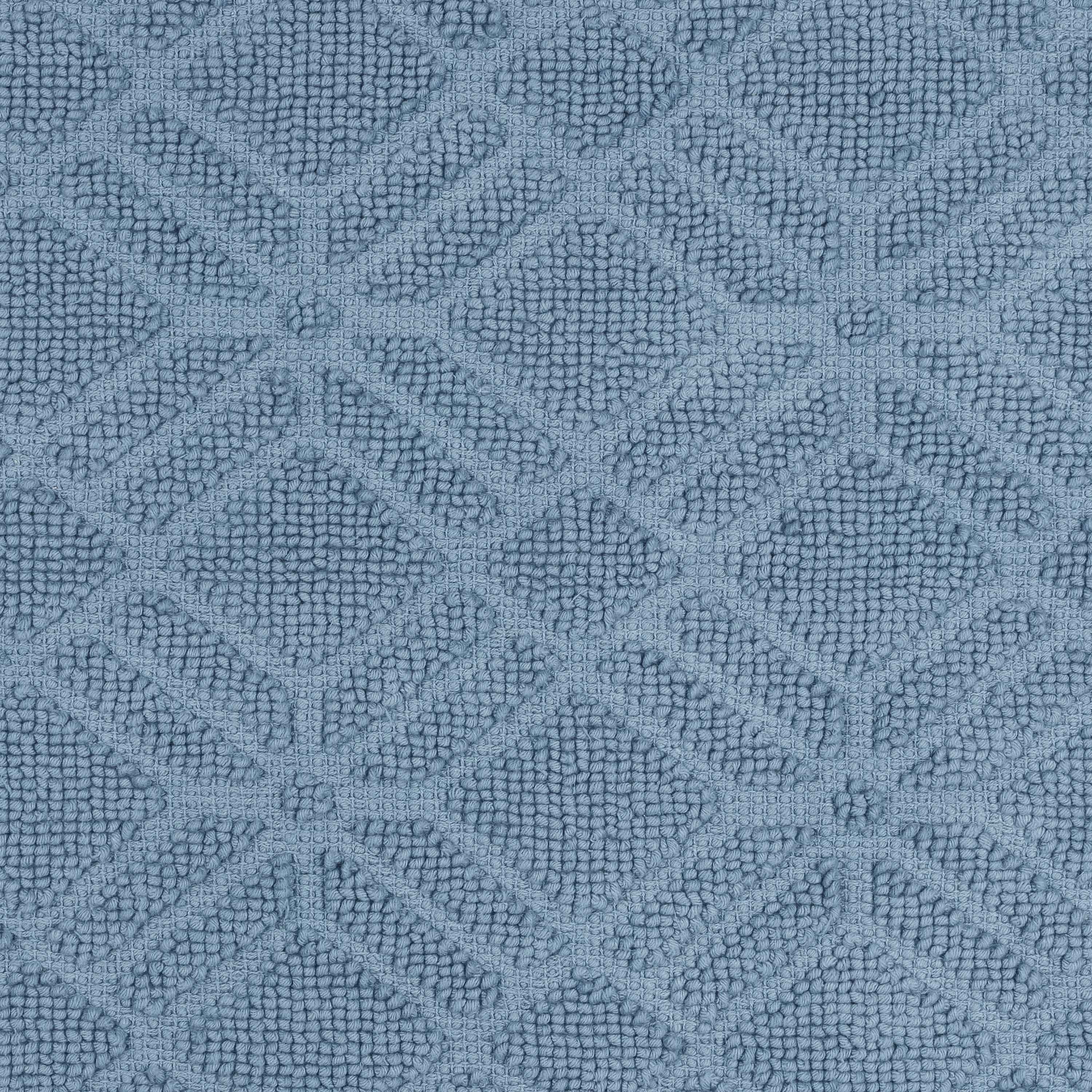 Textured blue bath rug featuring a geometric diamond pattern.