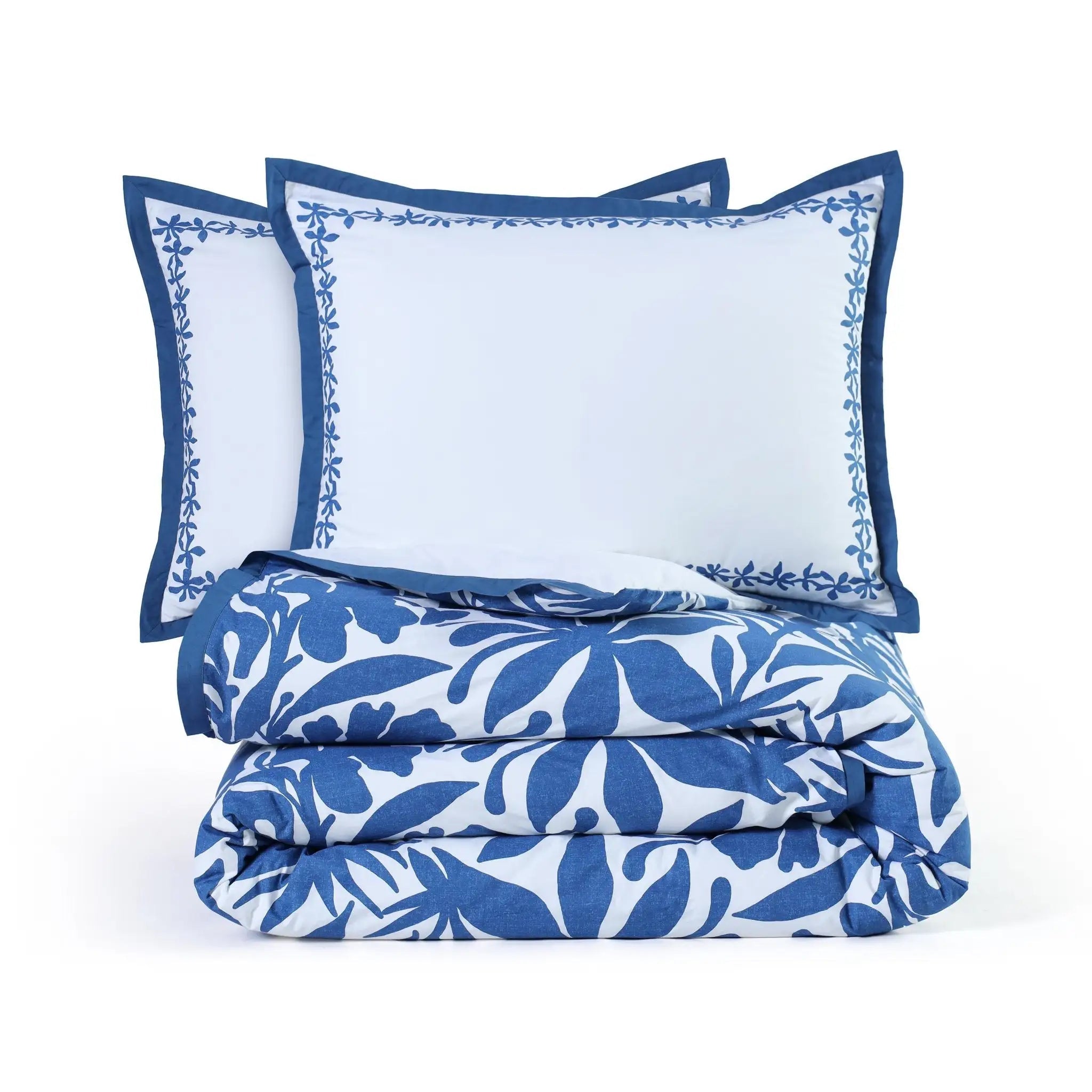 Blue and white floral comforter set with matching pillows on a white background