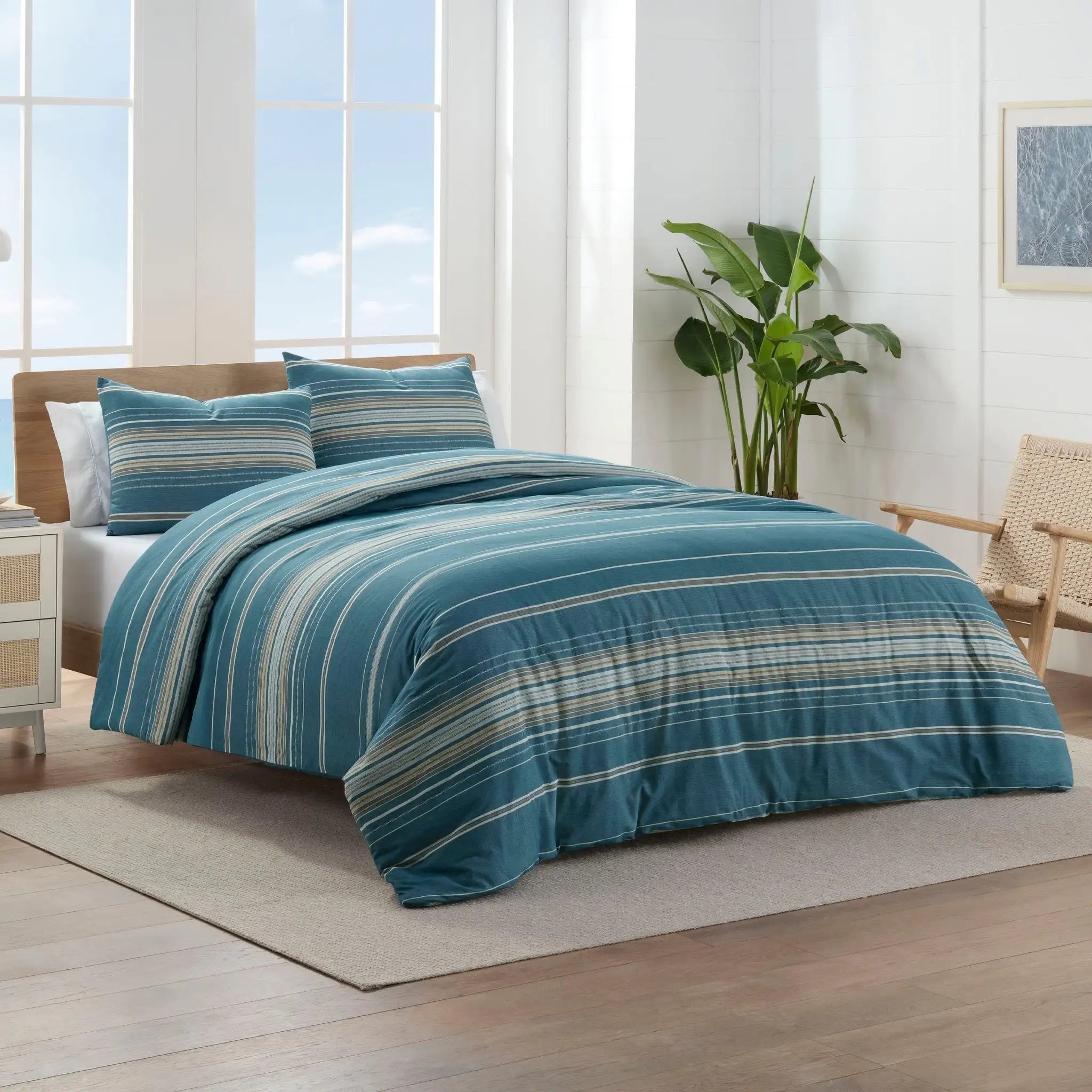 Blue striped comforter set on a bed.