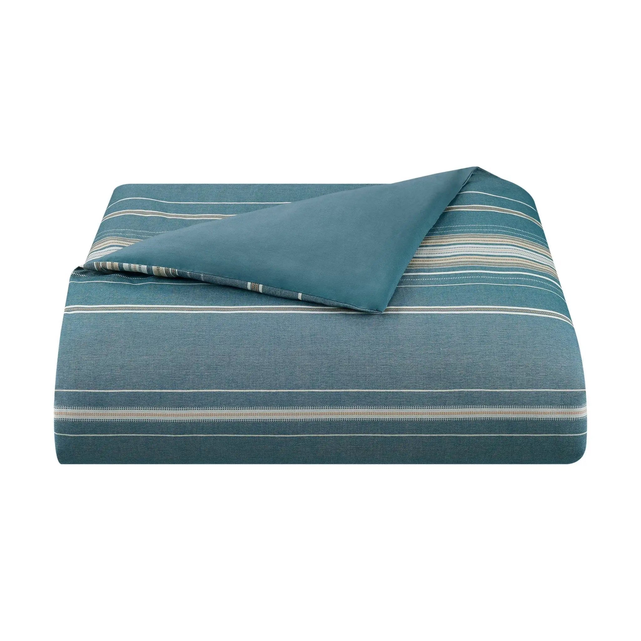 Blue striped comforter on a white background