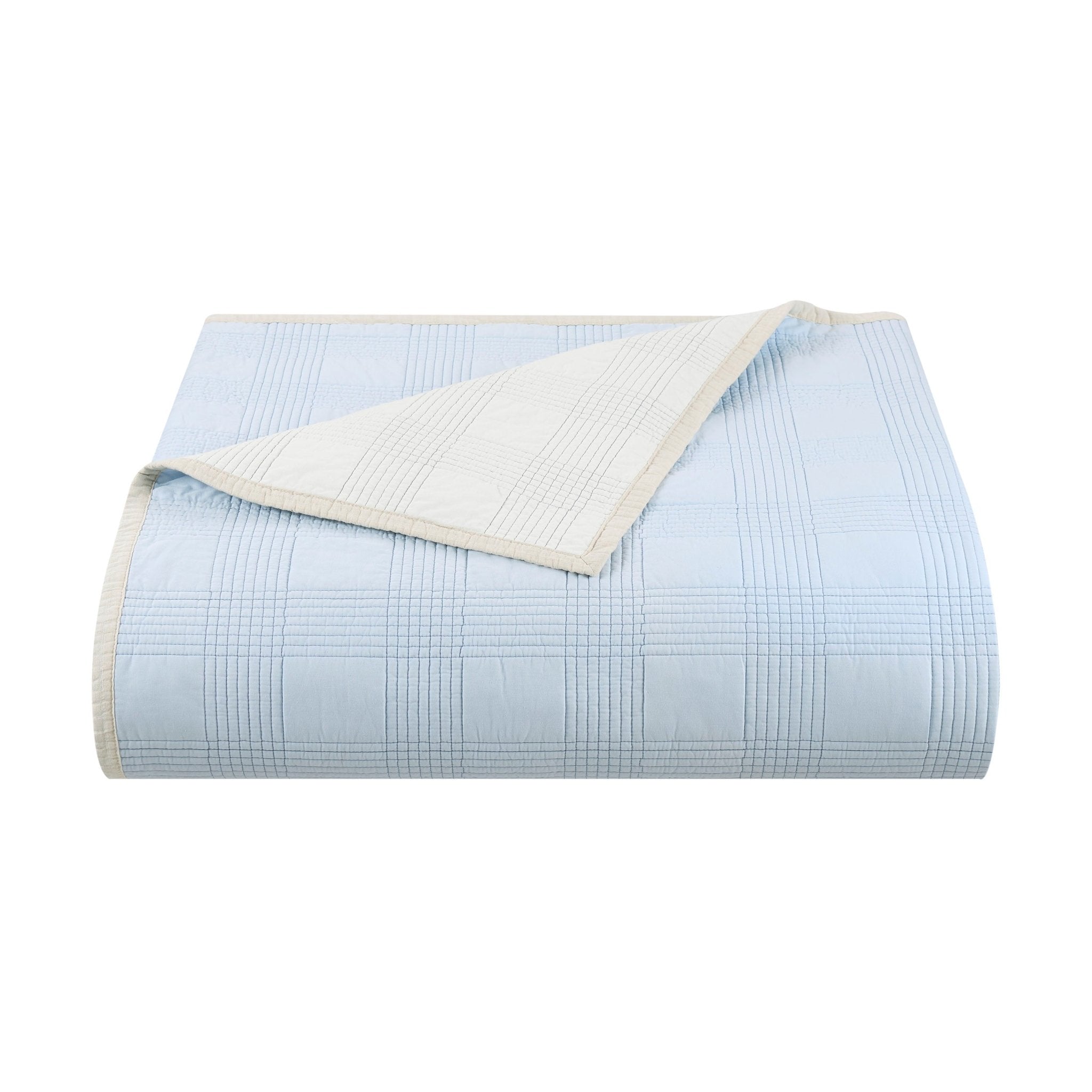 Light blue quilt with white checkered pattern on a white background