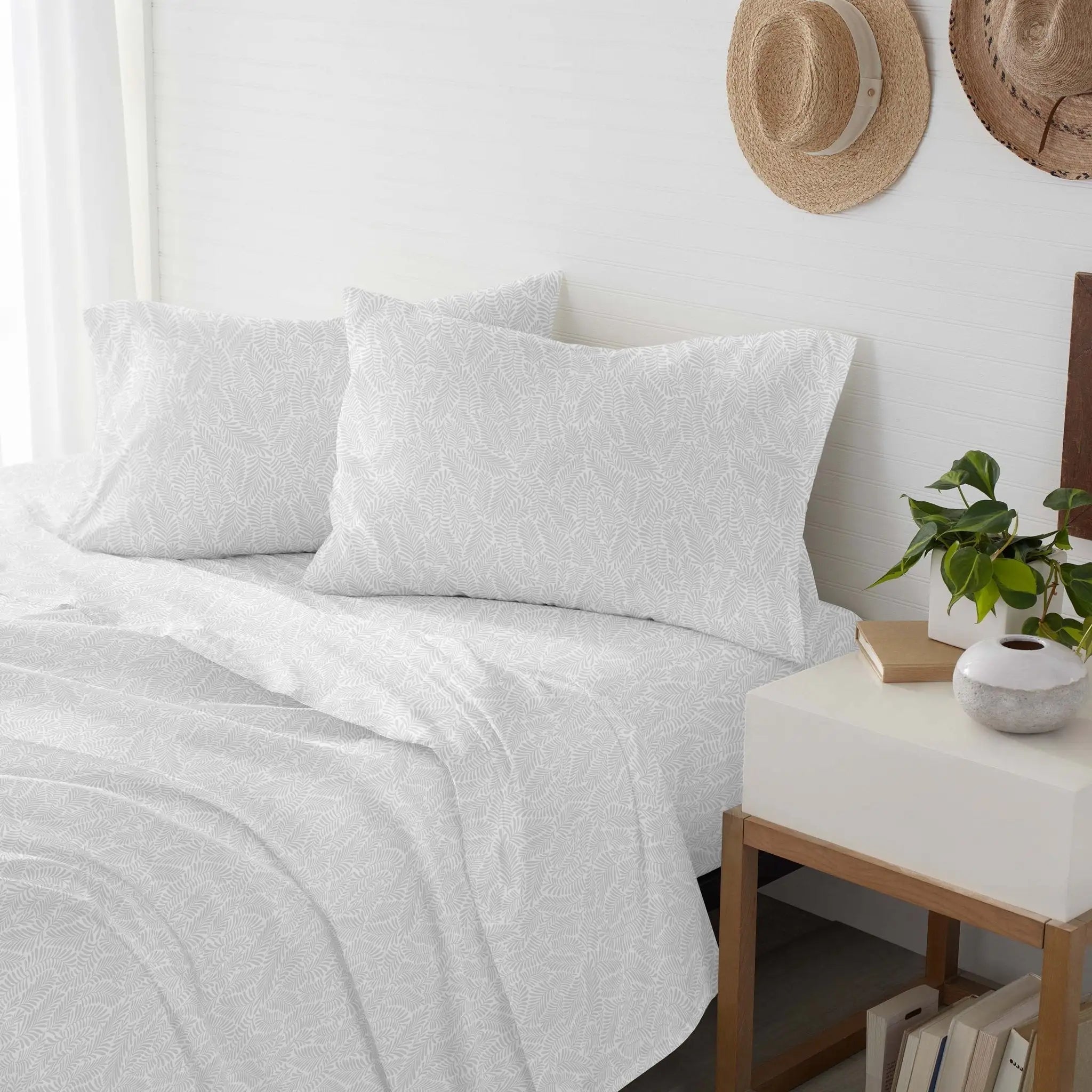 White textured bedding set on a bed.
