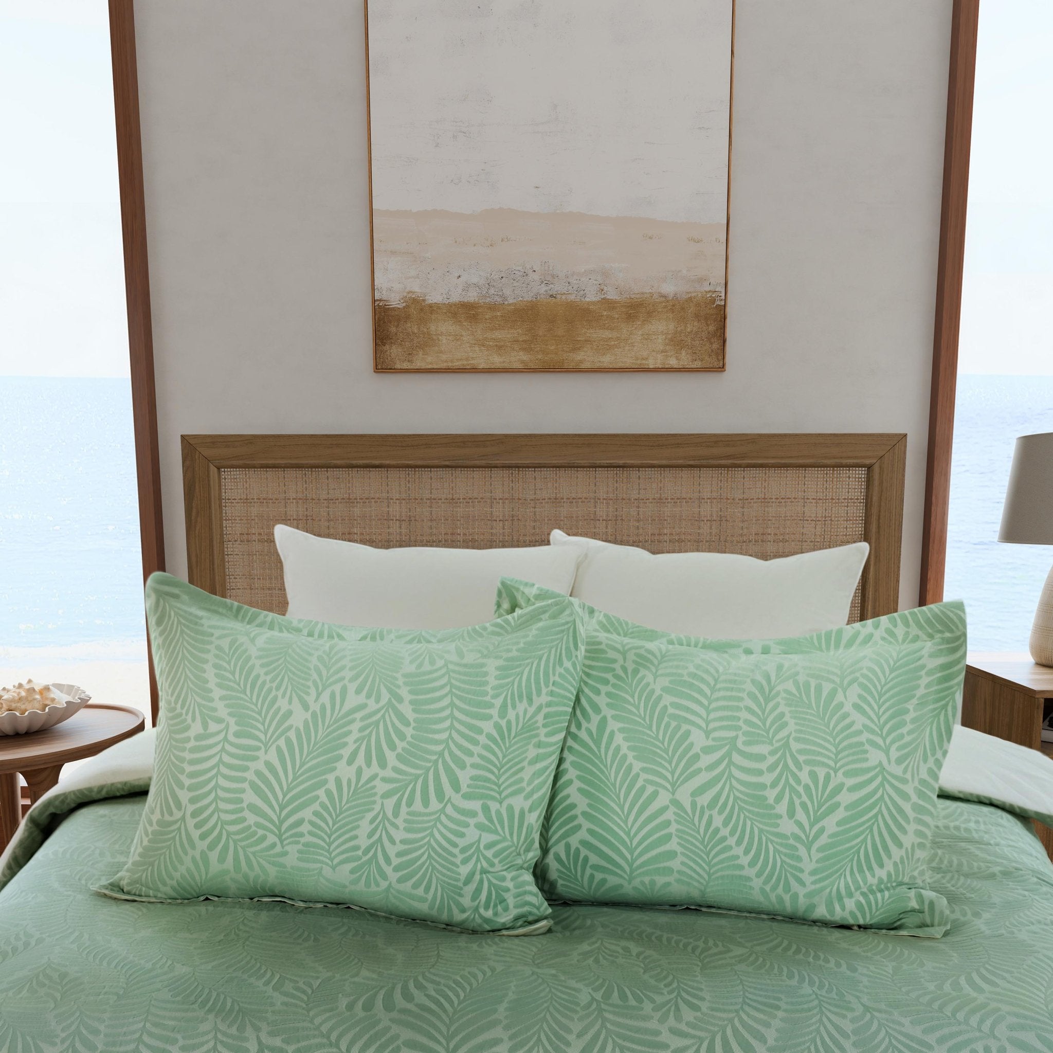 Green leaf-patterned shams on a bed