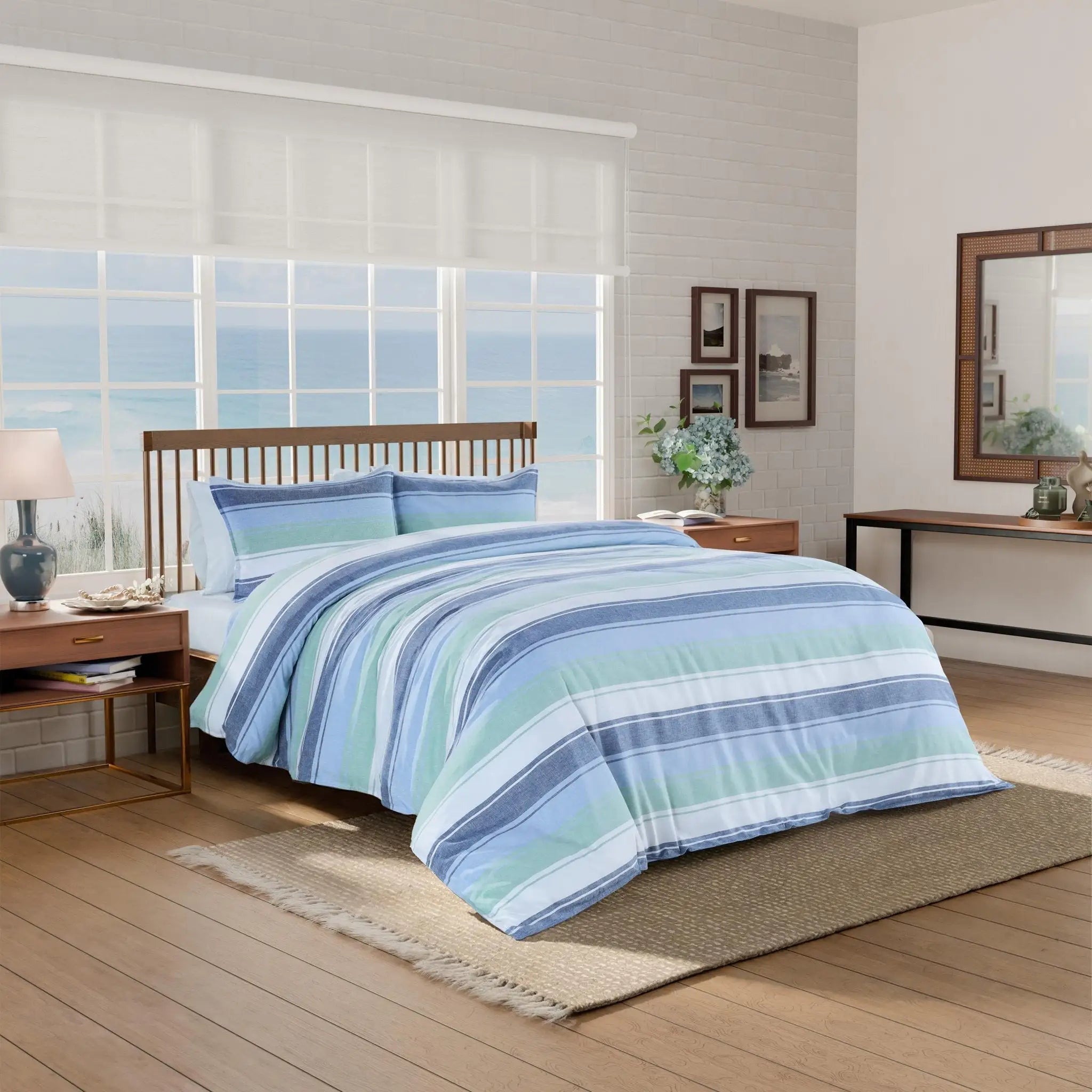 Bedroom with striped comforter set on a bed.