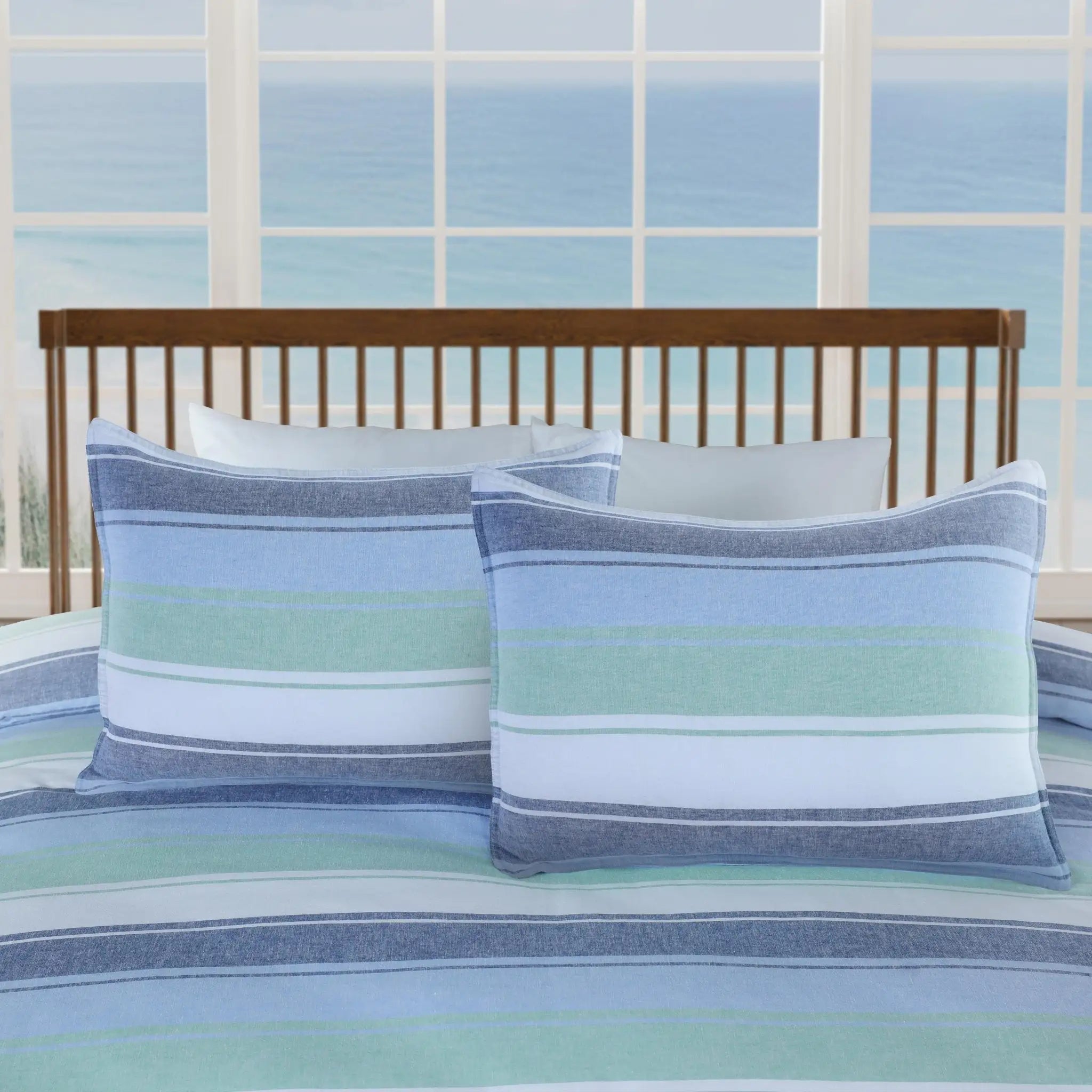 Striped pillow shams on a bed.
