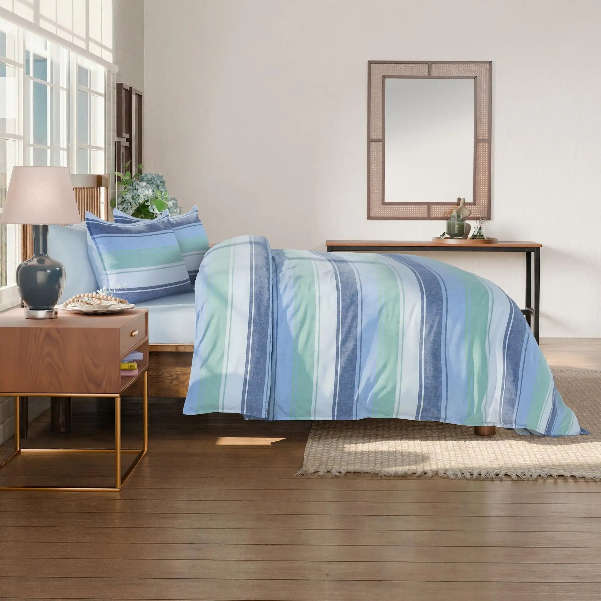 Bedroom with striped comforter set.